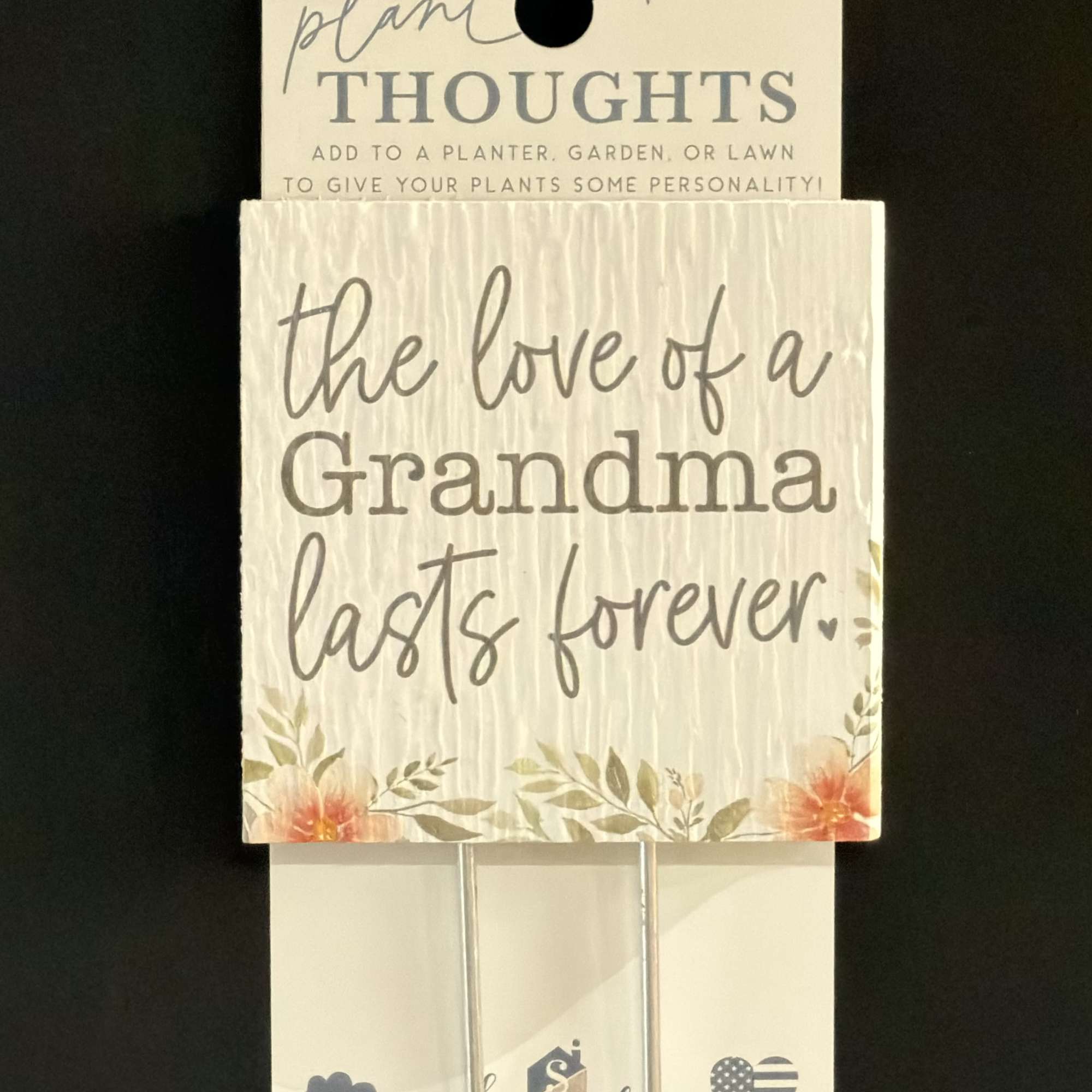 Packaged plant stake sign reading "the love of a Grandma lasts forever."