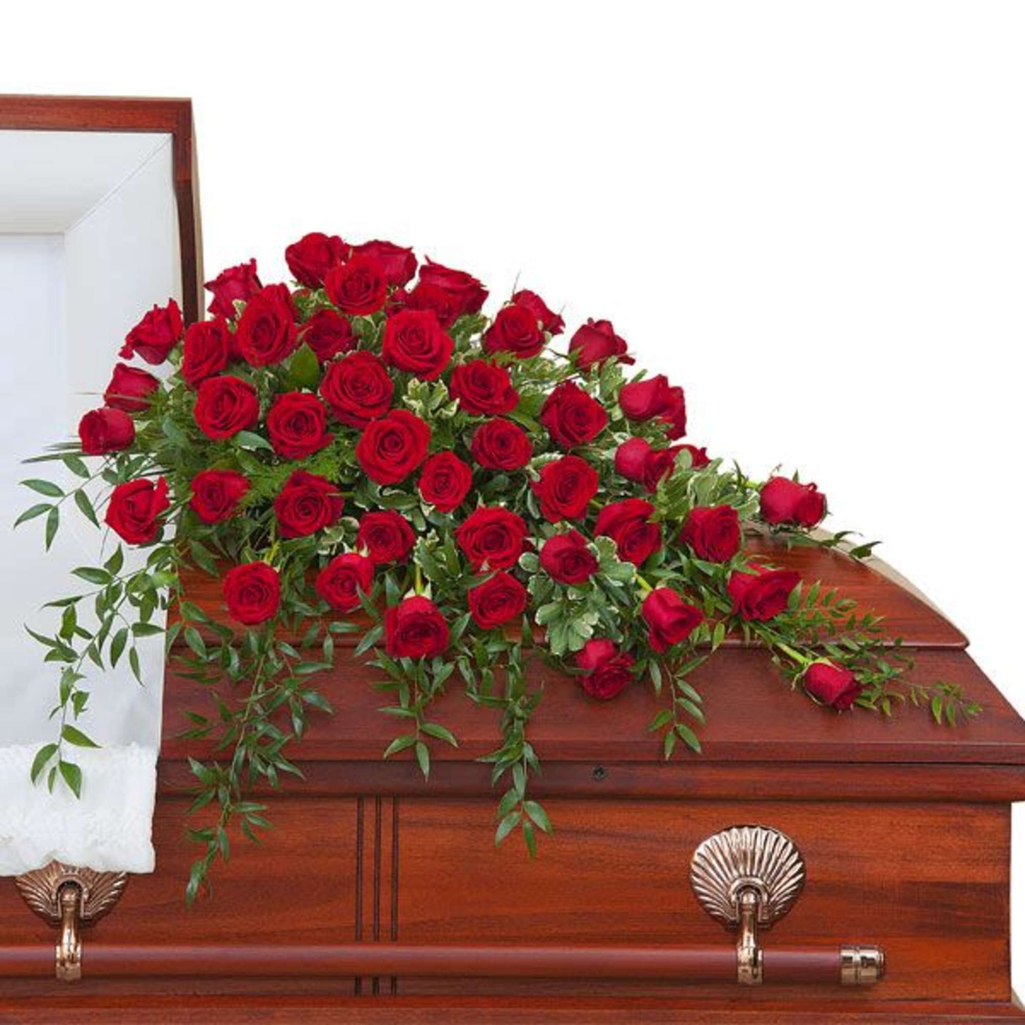 Red rose casket spray draped across a polished wood casket