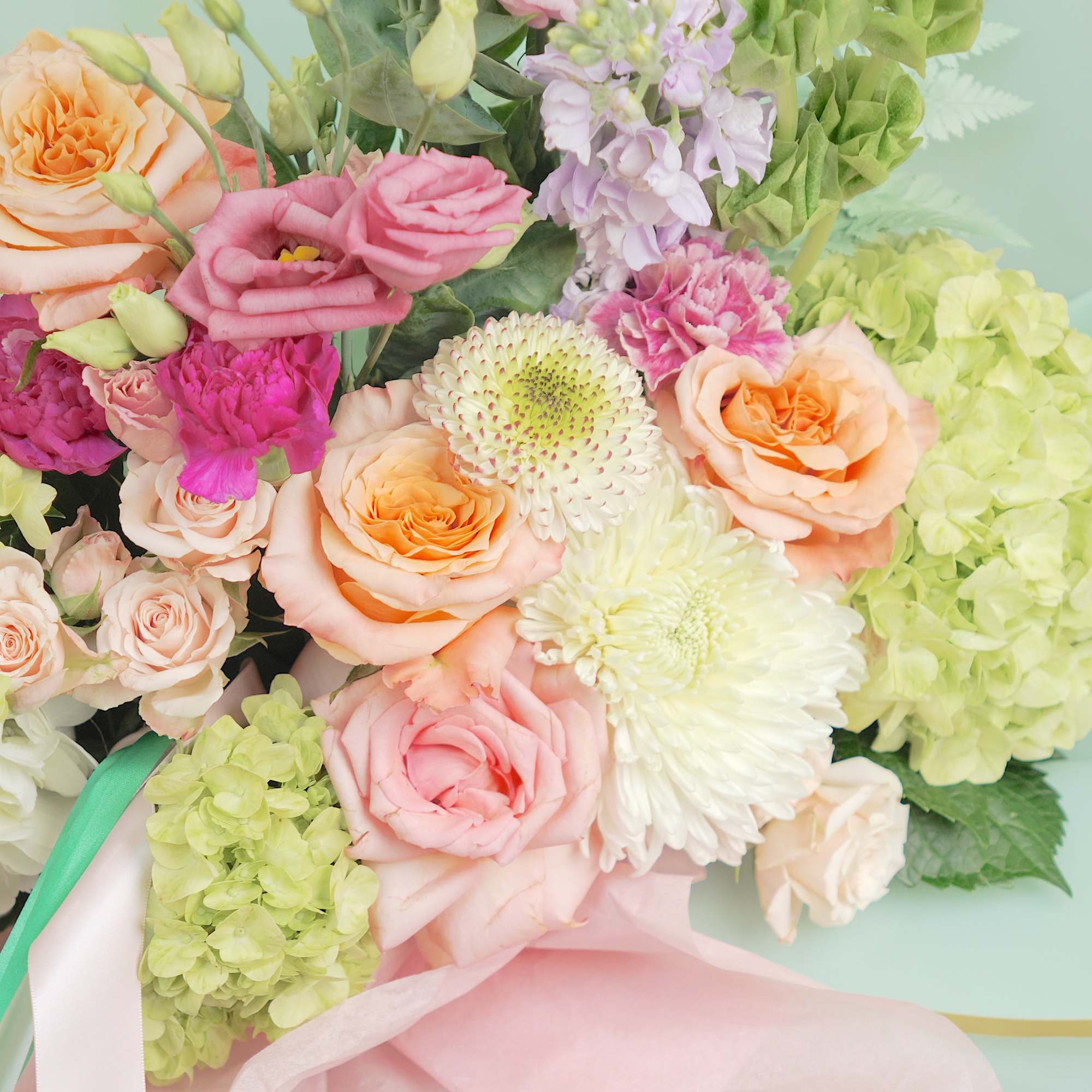 Pastel bouquet of roses, lisianthus, hydrangea, and chrysanthemums