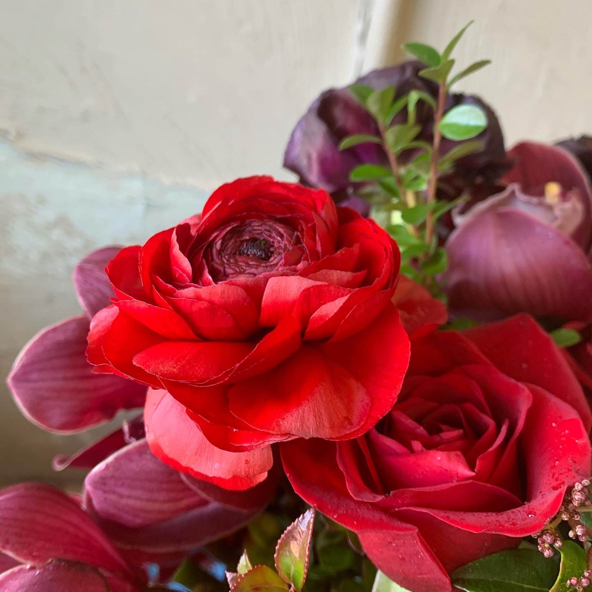 Red roses with purple calla lilies in a bouquet