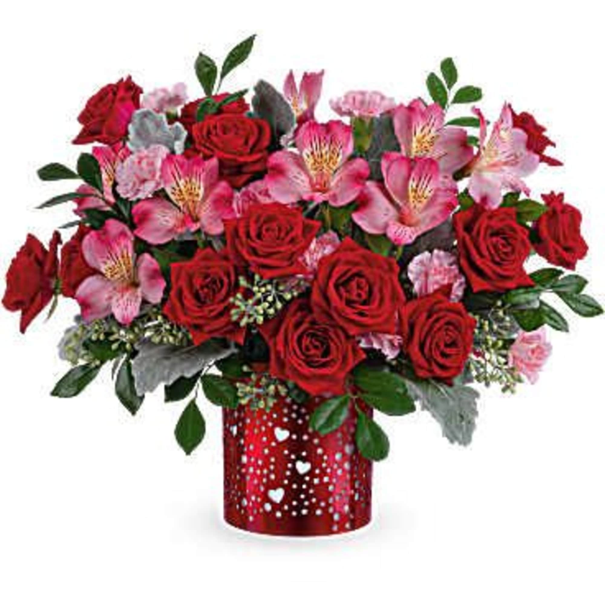 Red roses and pink flowers in a red heart-patterned vase