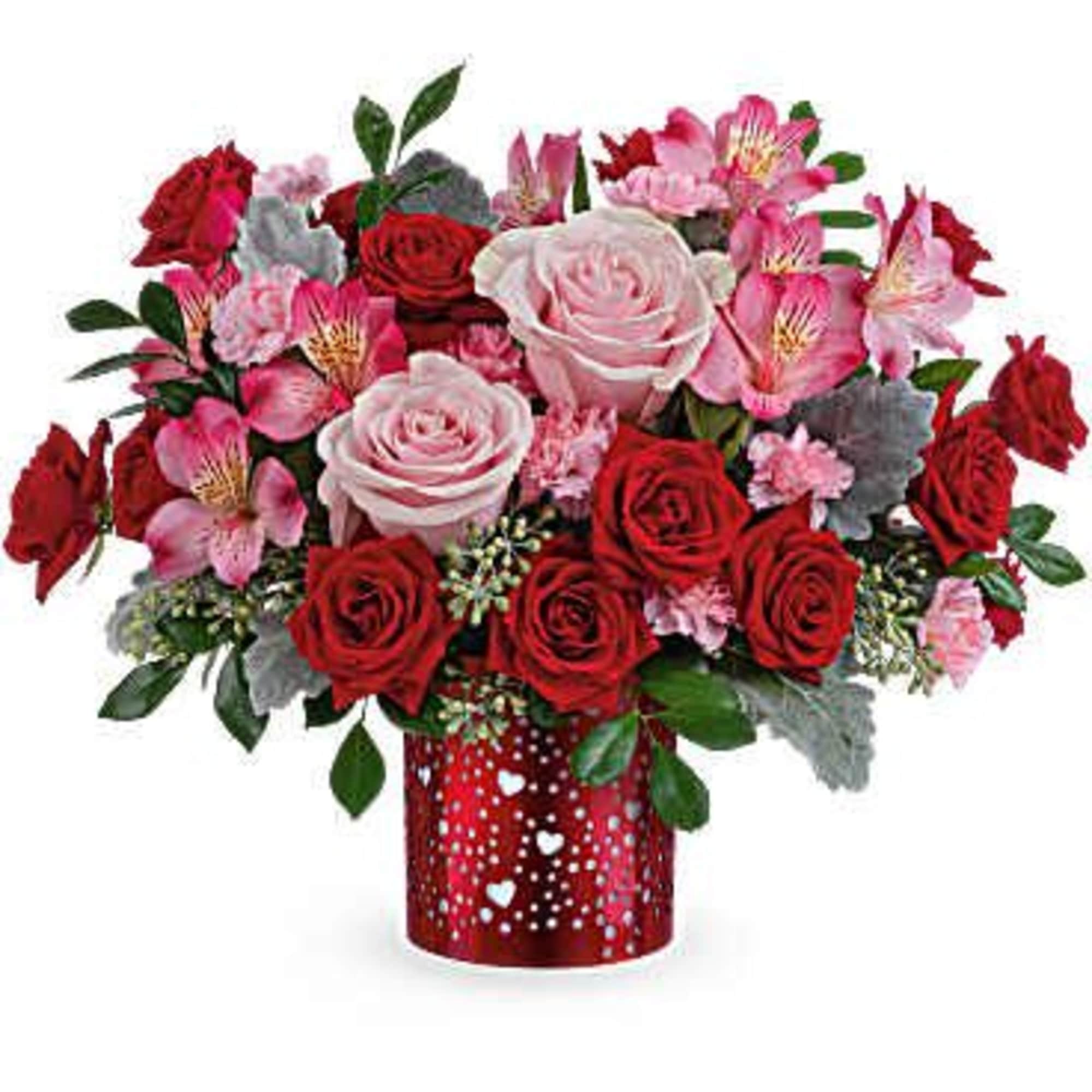 Red and pink rose bouquet in a red heart-patterned vase