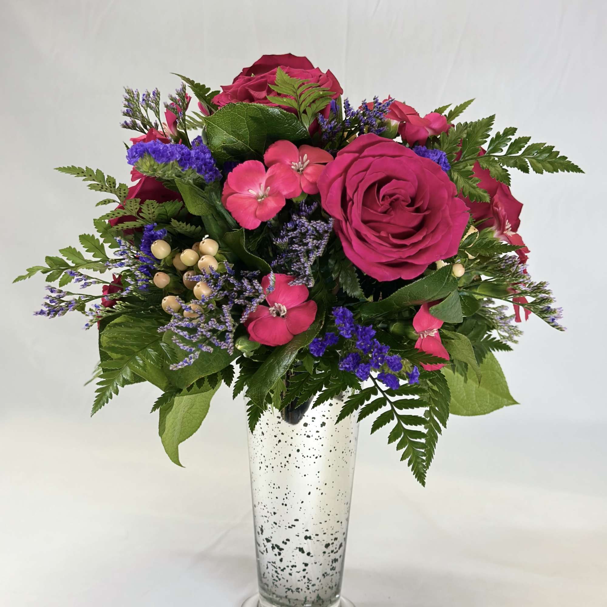 Pink rose bouquet in a tall clear vase