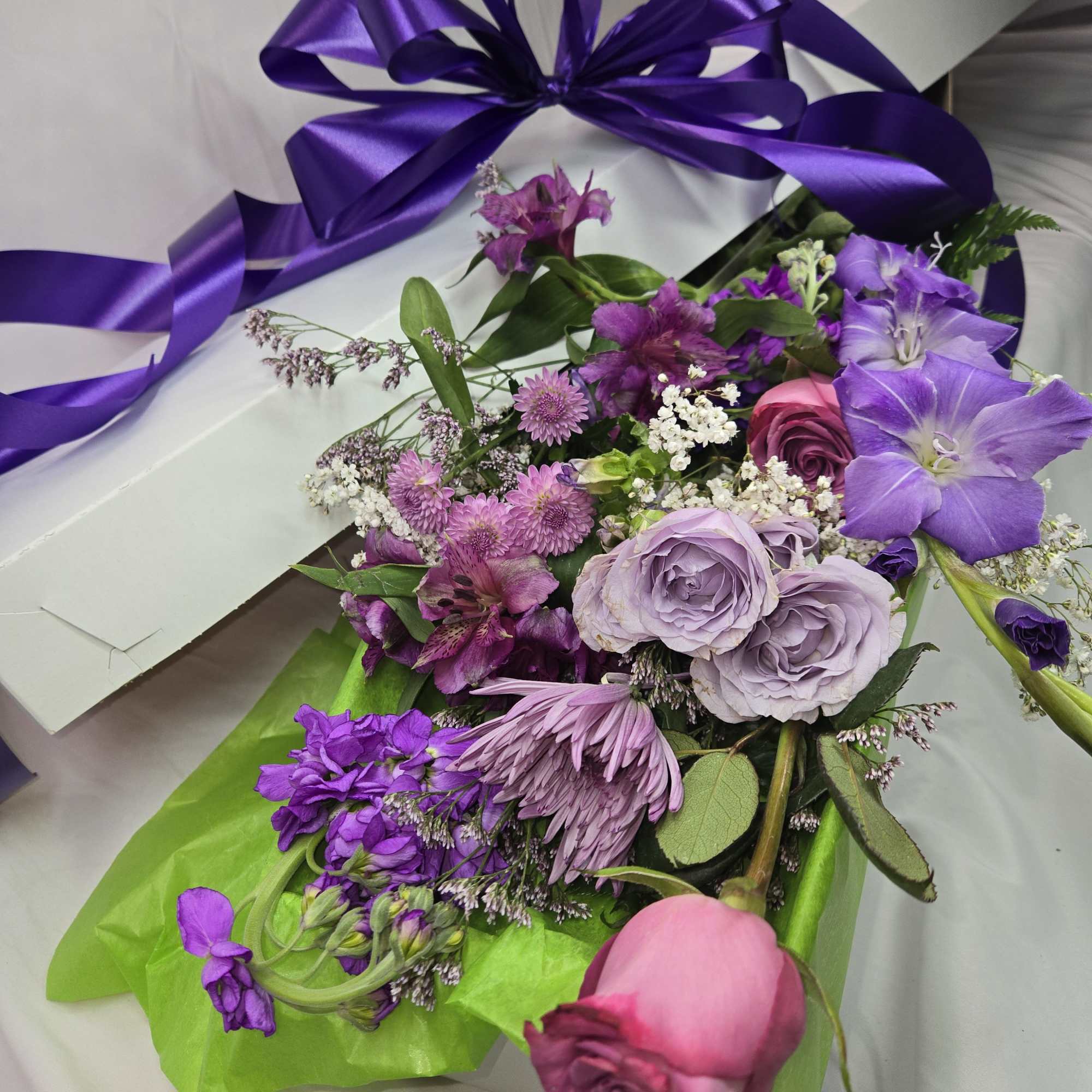 Purple and pink mixed bouquet with a large purple ribbon
