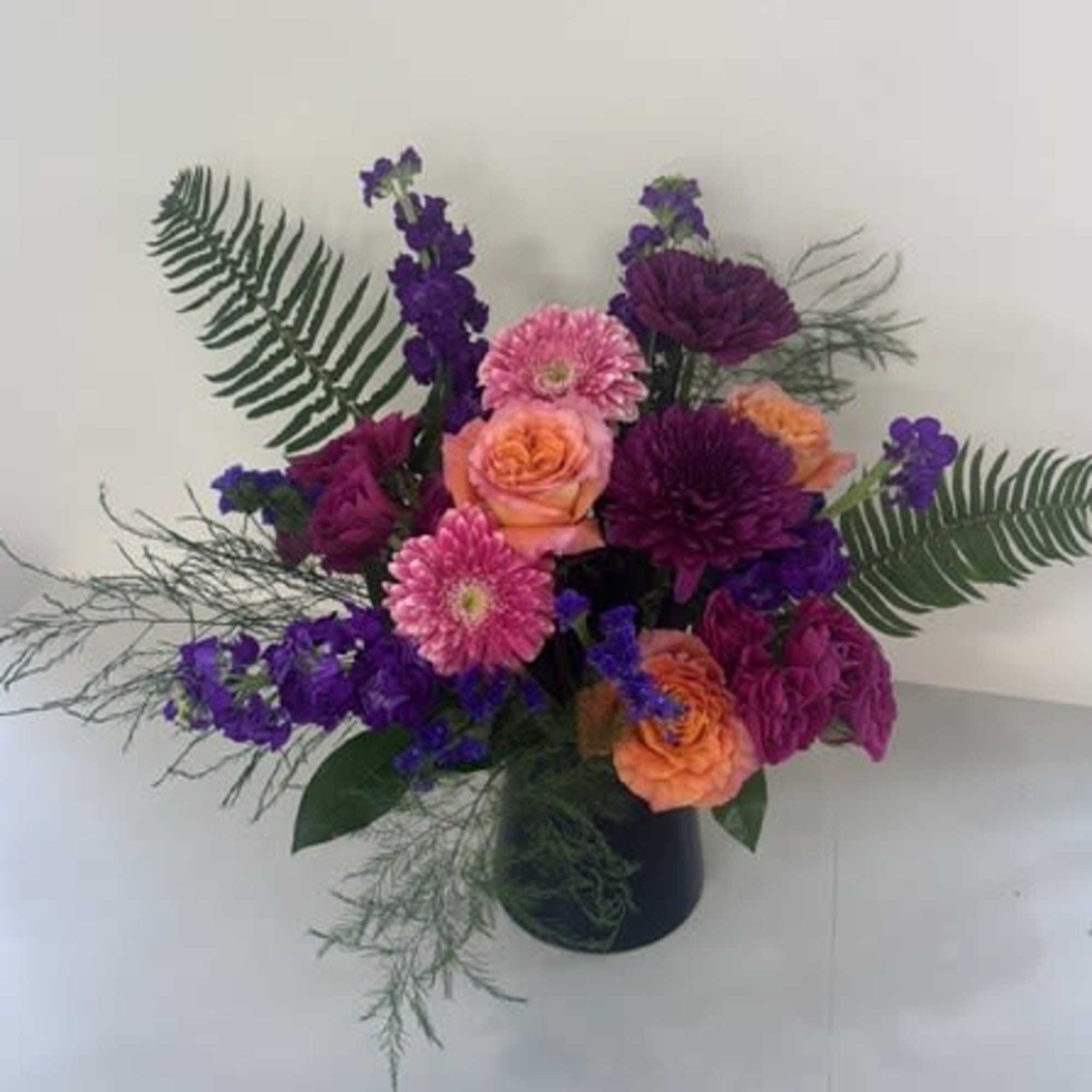 Electric Sunset is a striking arrangement bursting with bold color and modern