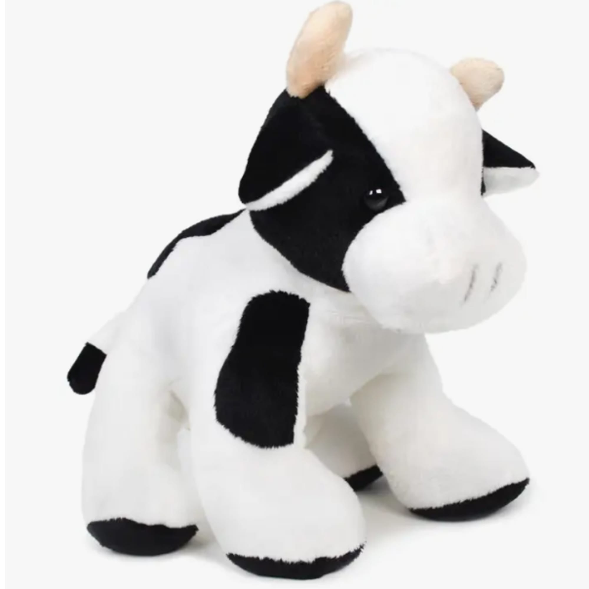 Black-and-white plush cow toy on a white background