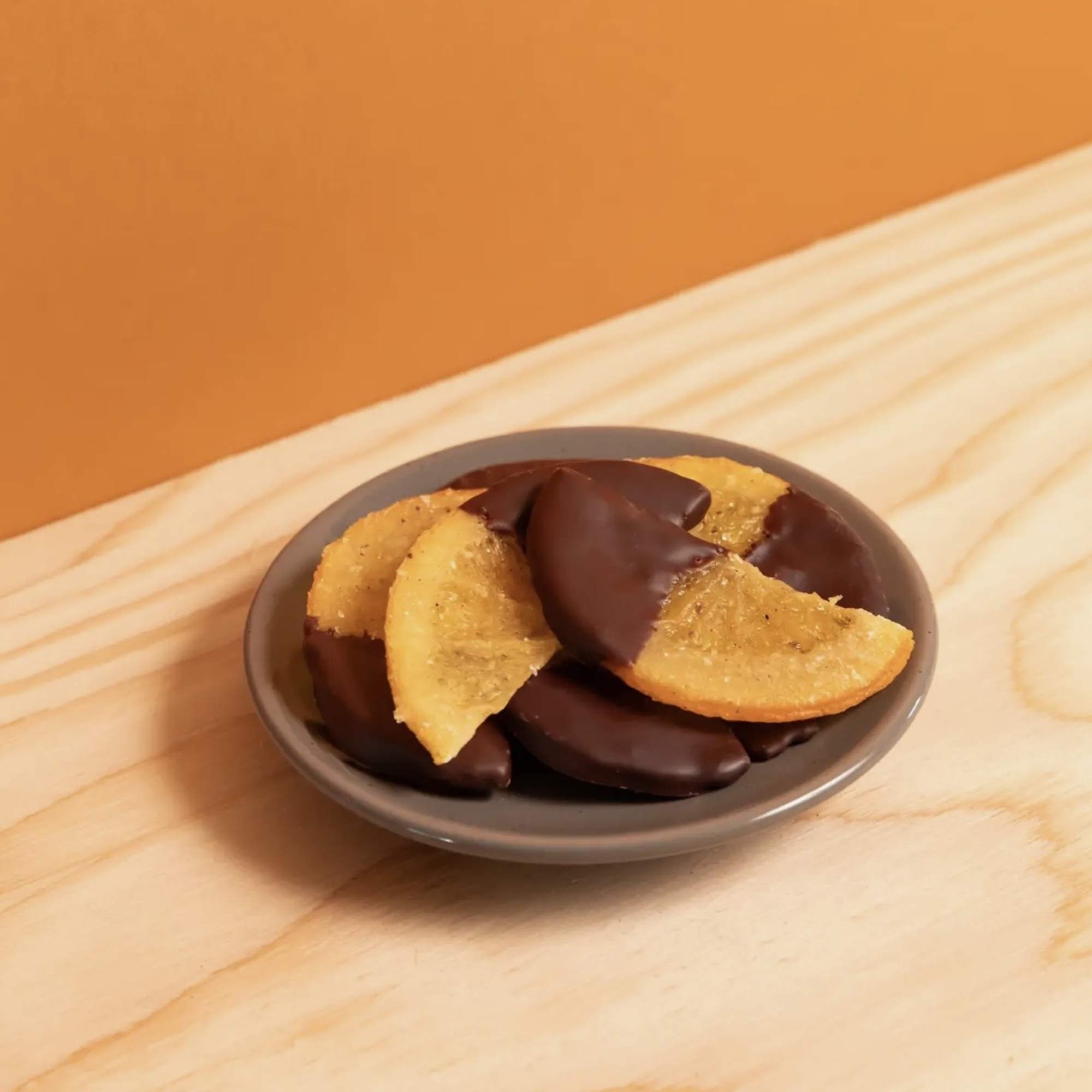 Chocolate-covered dried fruit slices in a small dish