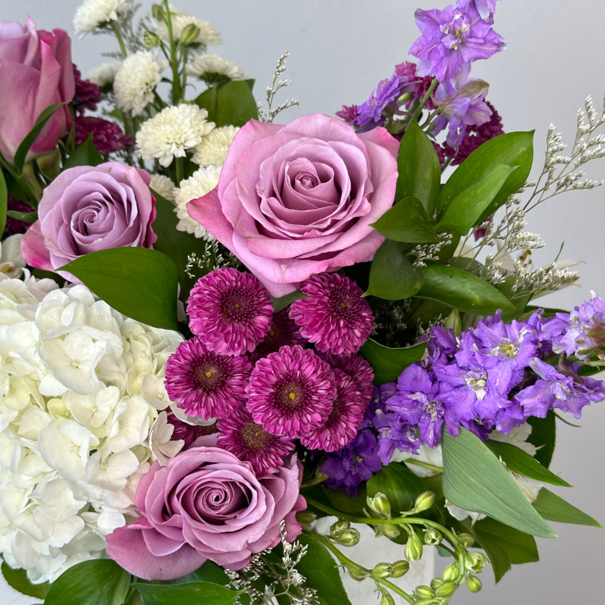 Bouquet of lavender roses, white hydrangea, and purple flowers