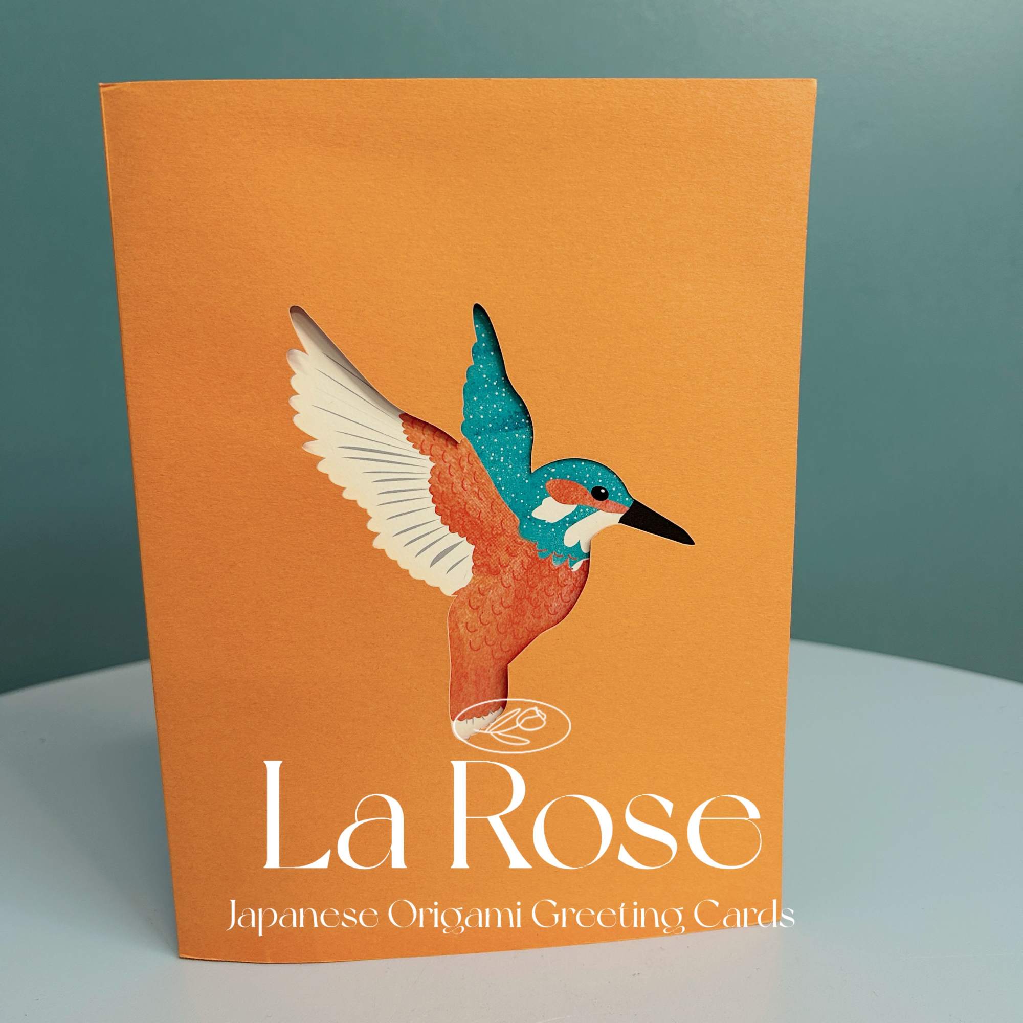 Orange greeting card with a colorful bird illustration and white text