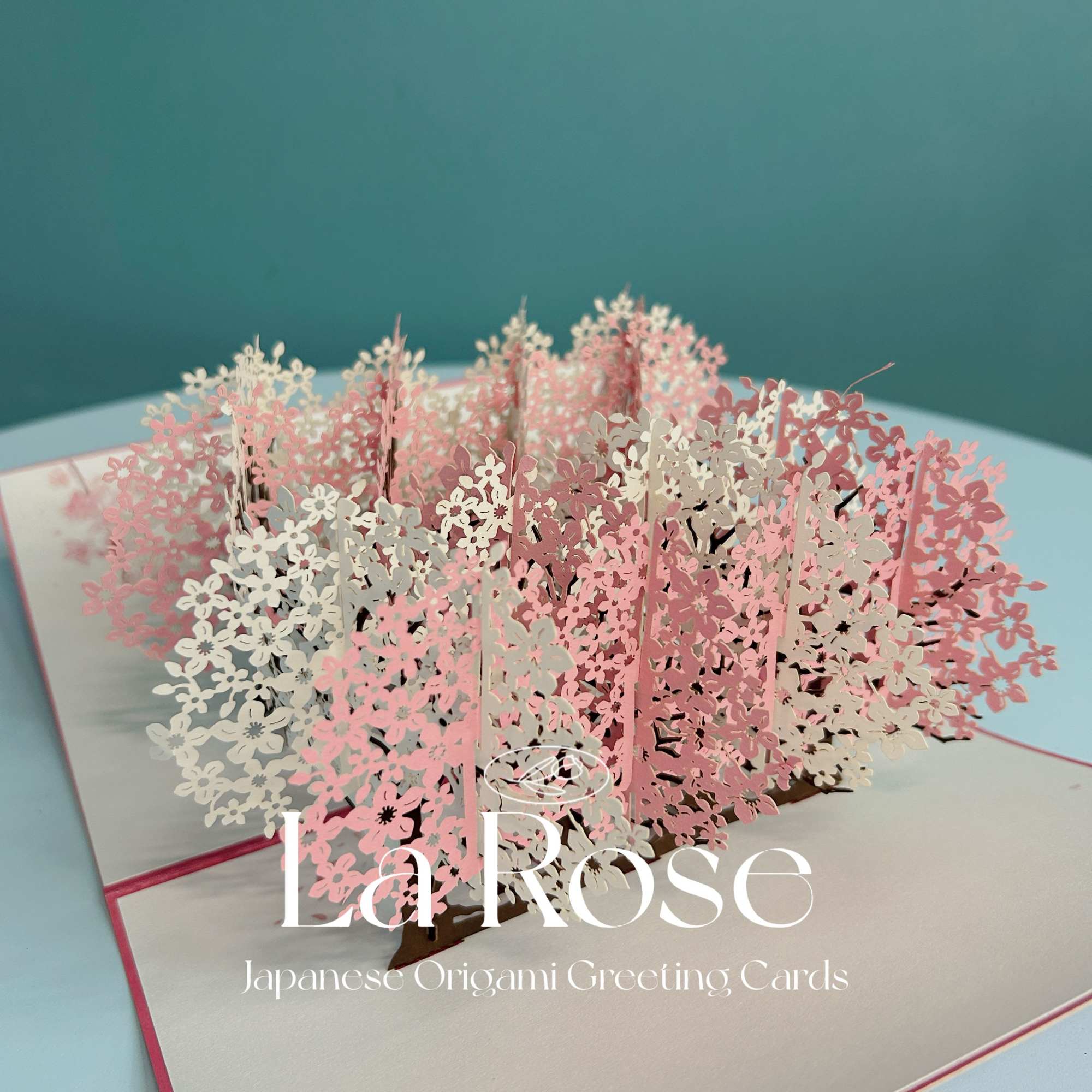 Pop-up greeting card with pink and white floral cutouts