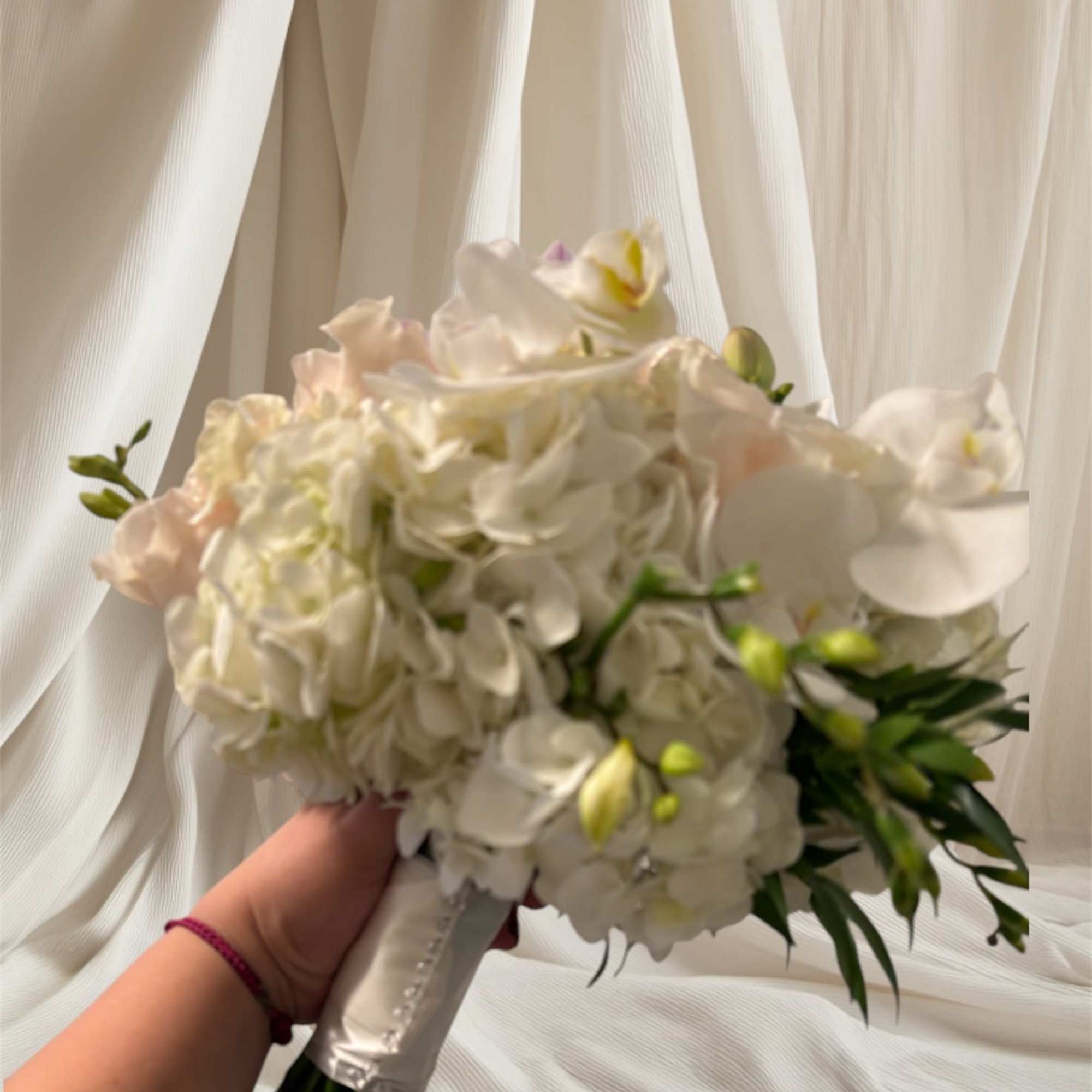 White bridal bouquet with orchids and hydrangeas, photo 2 of 3