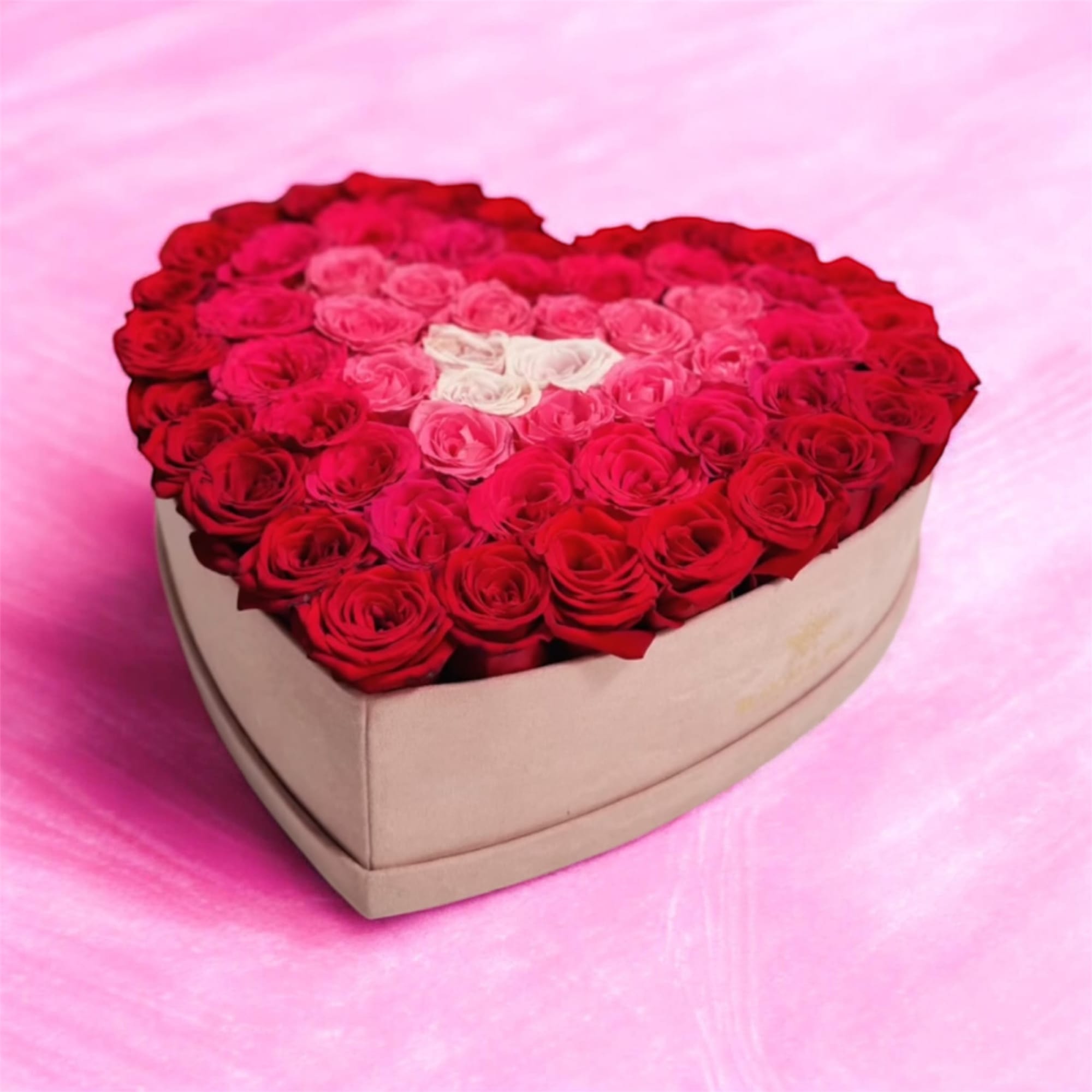 Heart-shaped box filled with red and pink roses