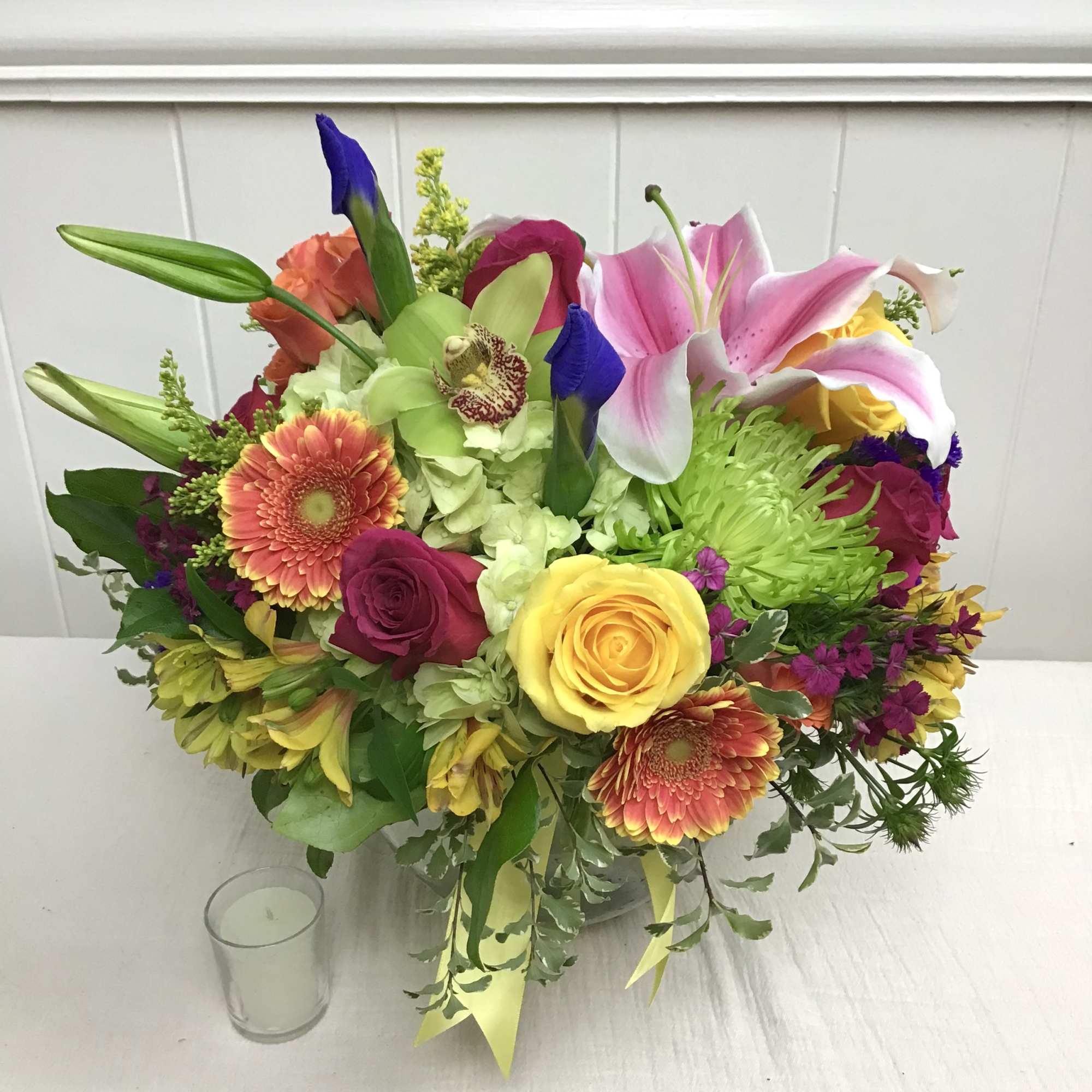 Colorful mixed bouquet with lilies, roses, and gerbera daisies in a vase