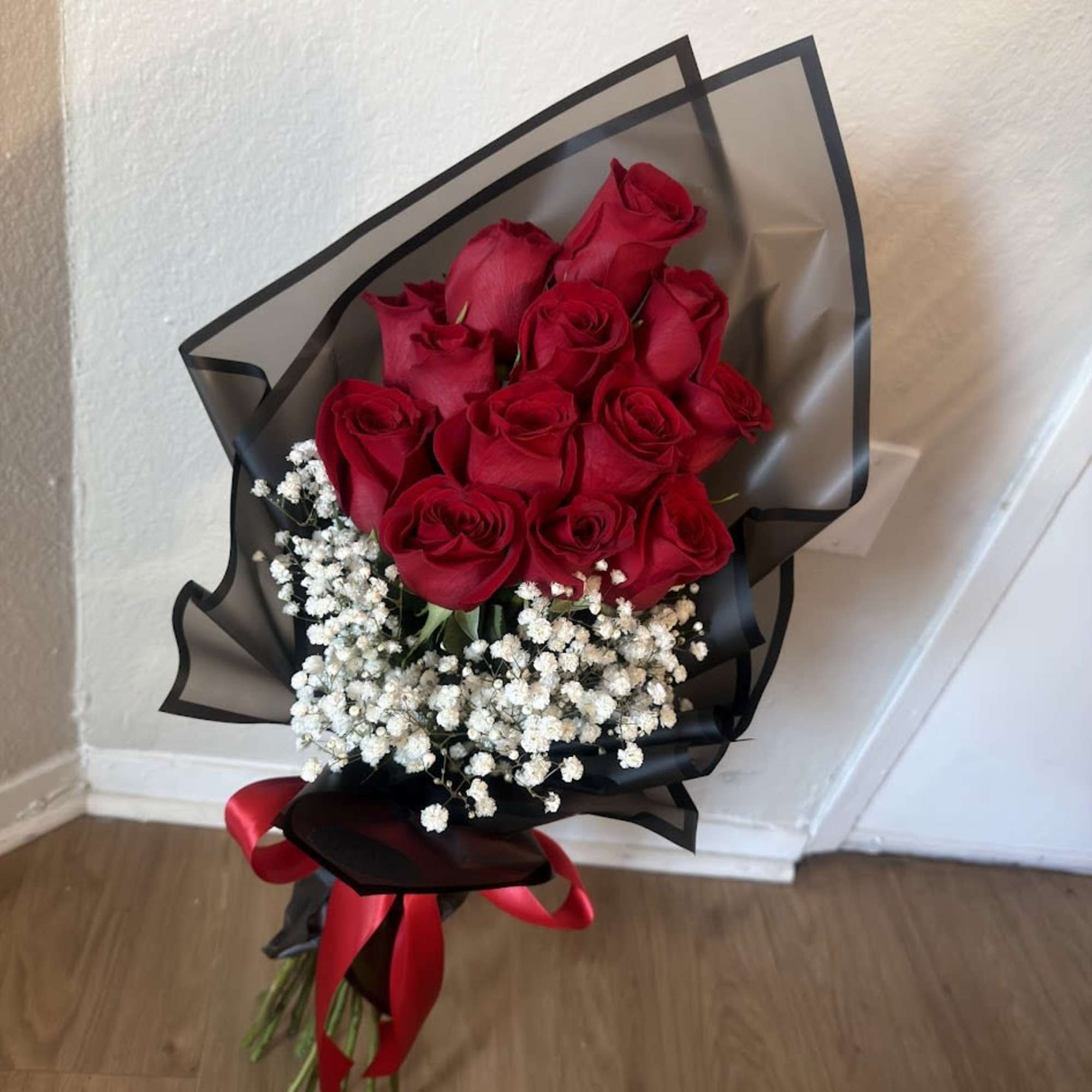 An elegant arrangement of fresh red roses, accompanied by delicate gypsophila that, photo 2 of 4