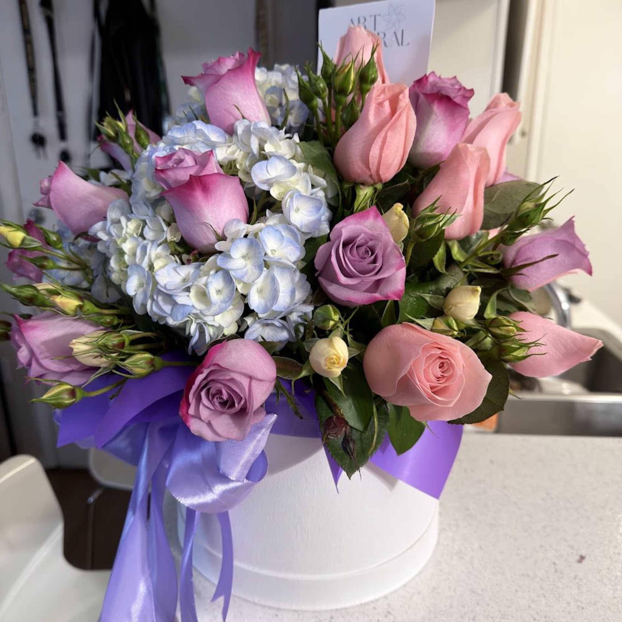 An elegant flower box featuring a beautiful blend of lavender roses, pink, photo 2 of 4