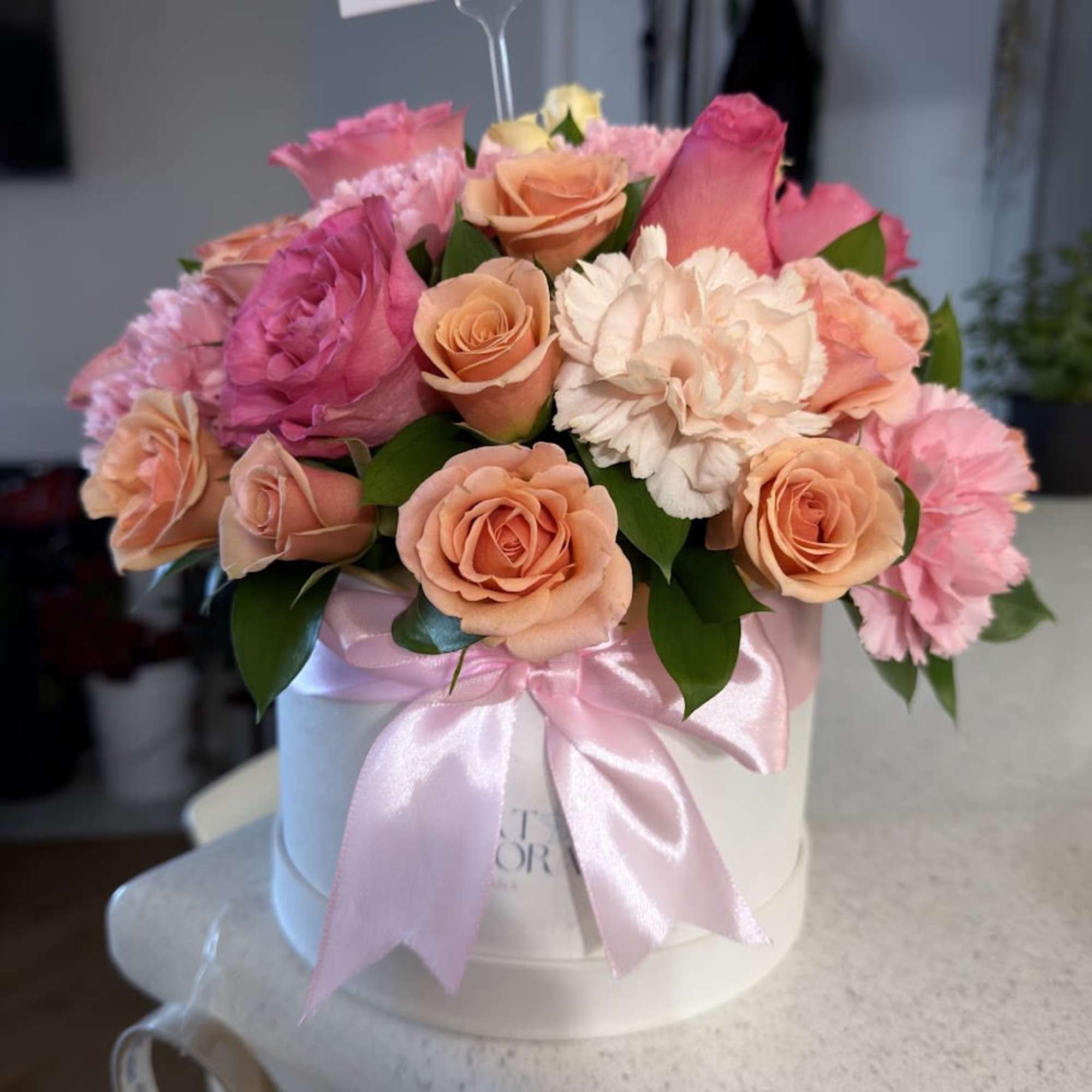 An elegant and colorful arrangement featuring carnations, orange and pink roses, beautifully, photo 4 of 5