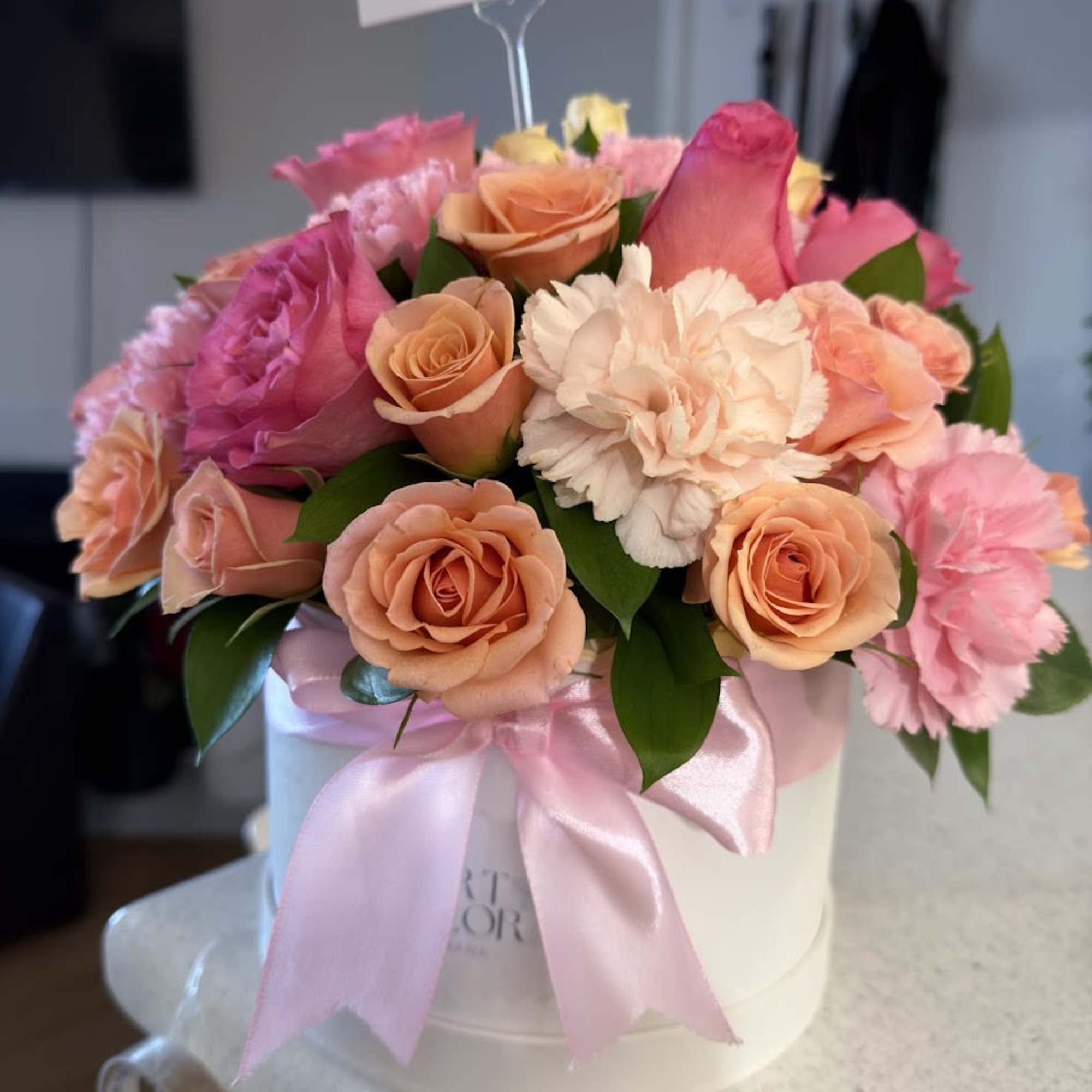 An elegant and colorful arrangement featuring carnations, orange and pink roses, beautifully, photo 5 of 5