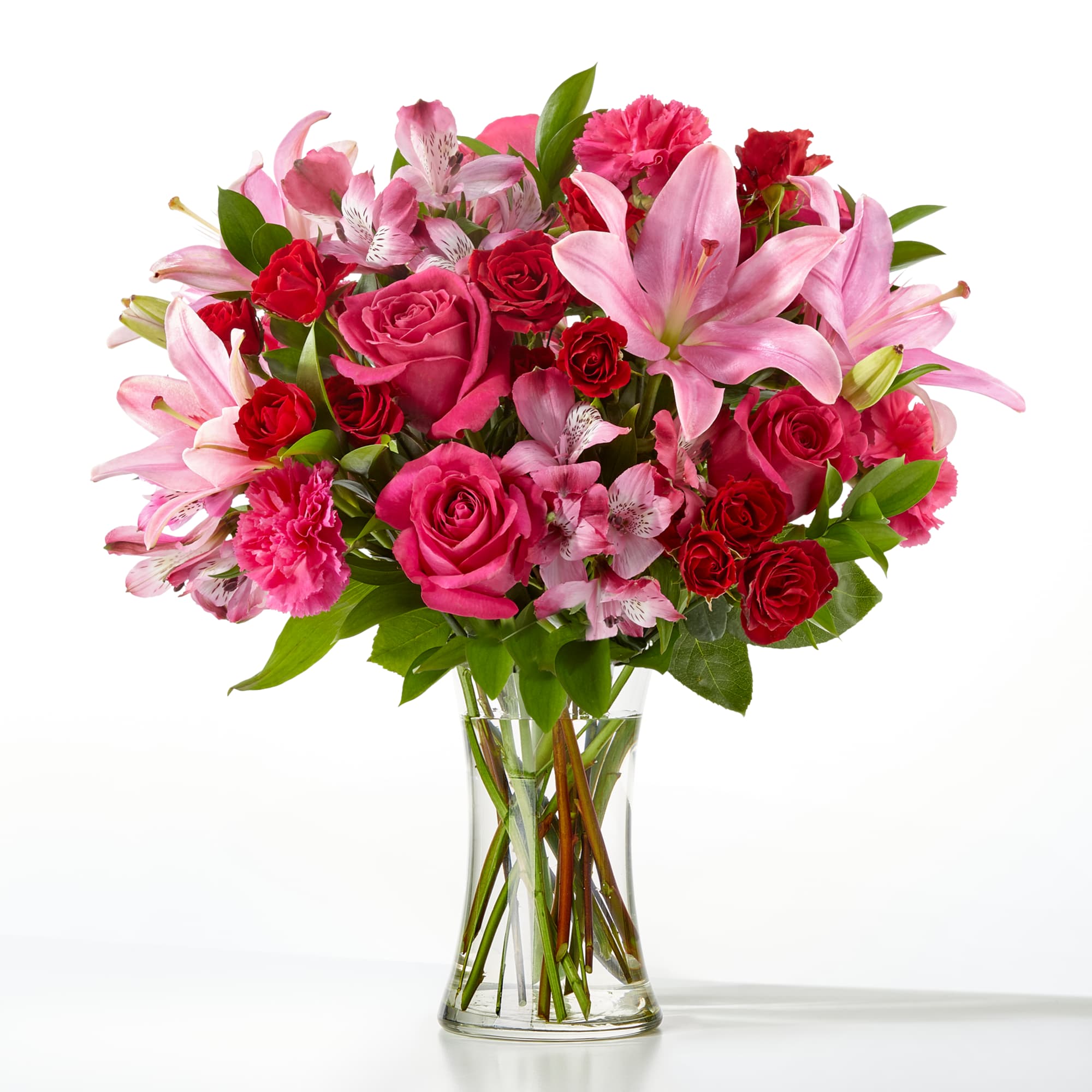 Pink and red mixed bouquet in a clear glass vase
