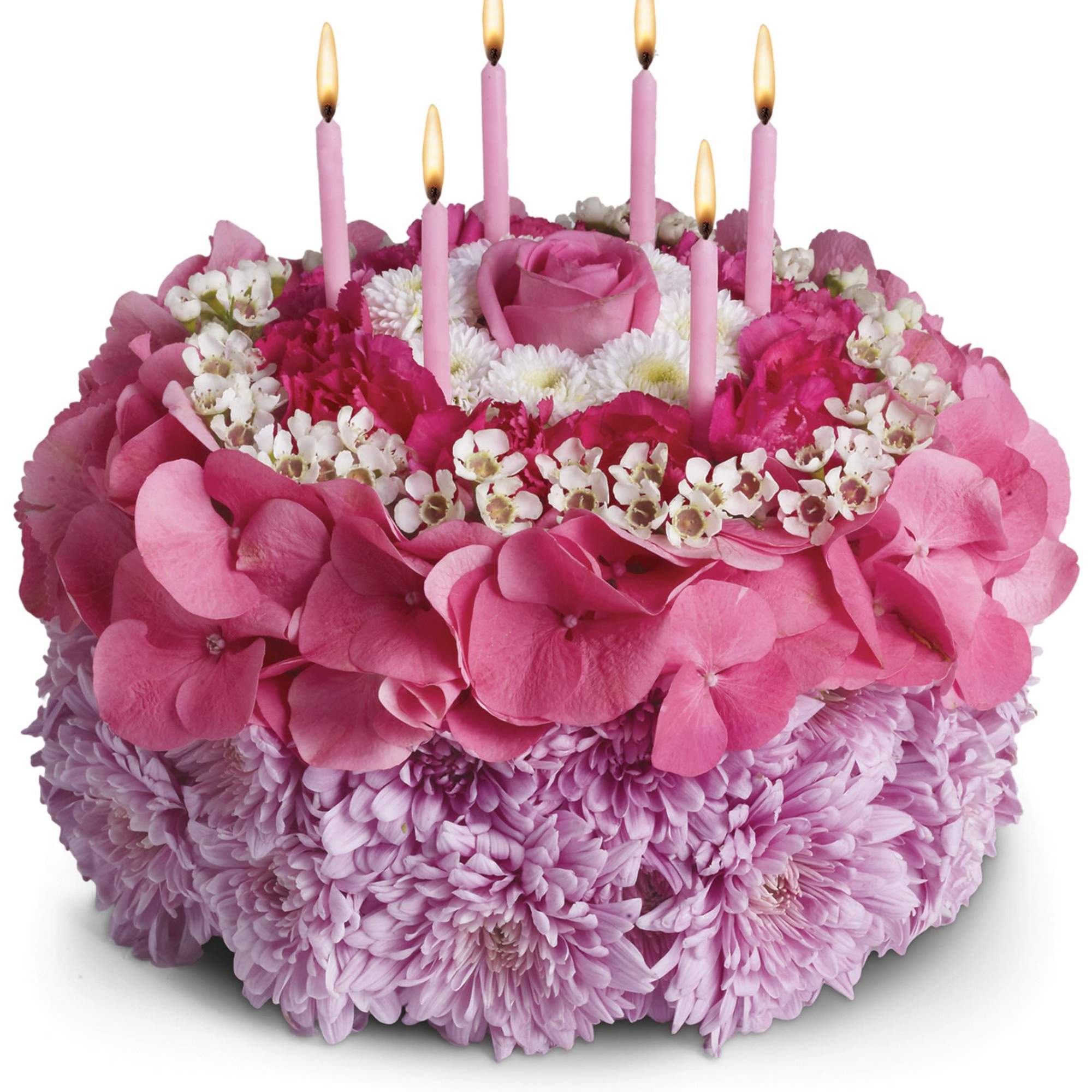 Pink floral cake with lit candles on top