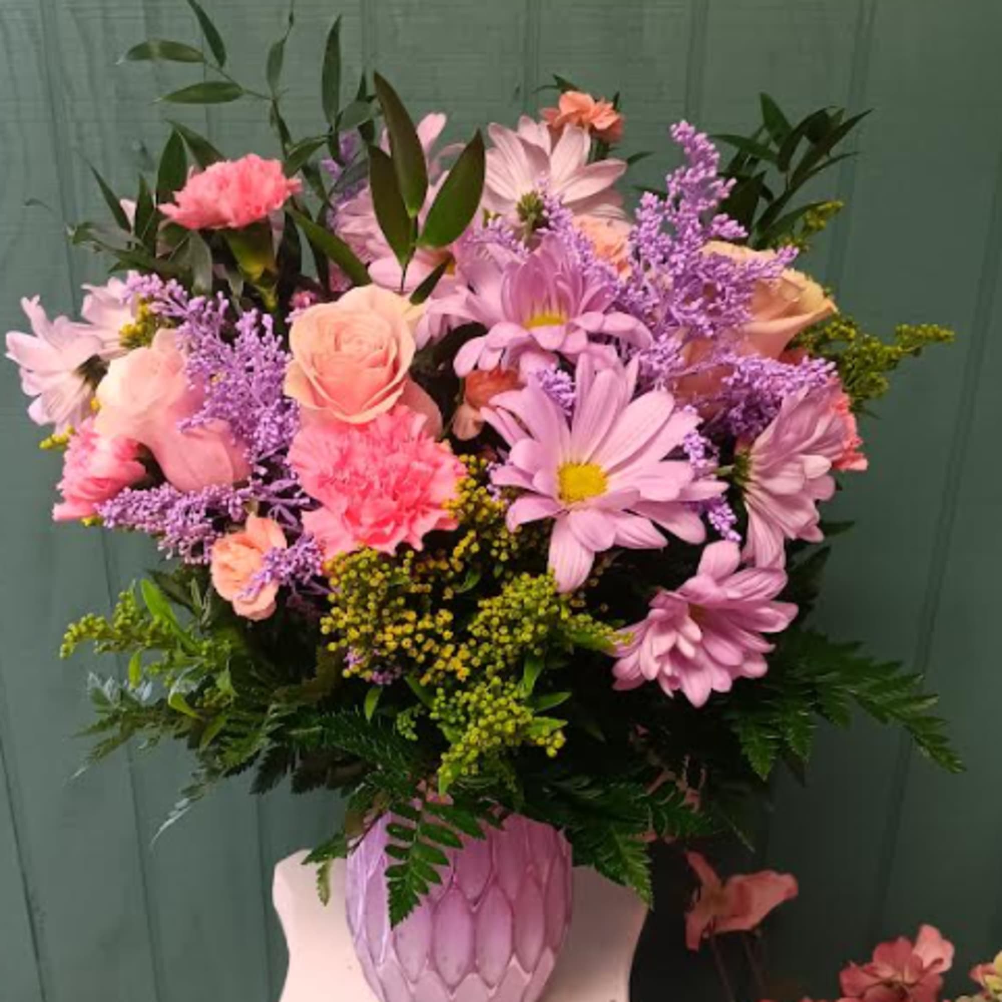 Pink and lavender mixed bouquet in a textured pink vase