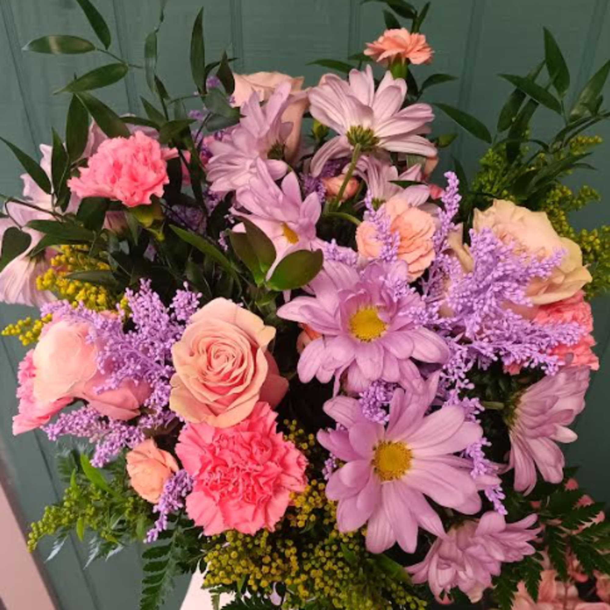 Bouquet of pink and lavender flowers with peach roses