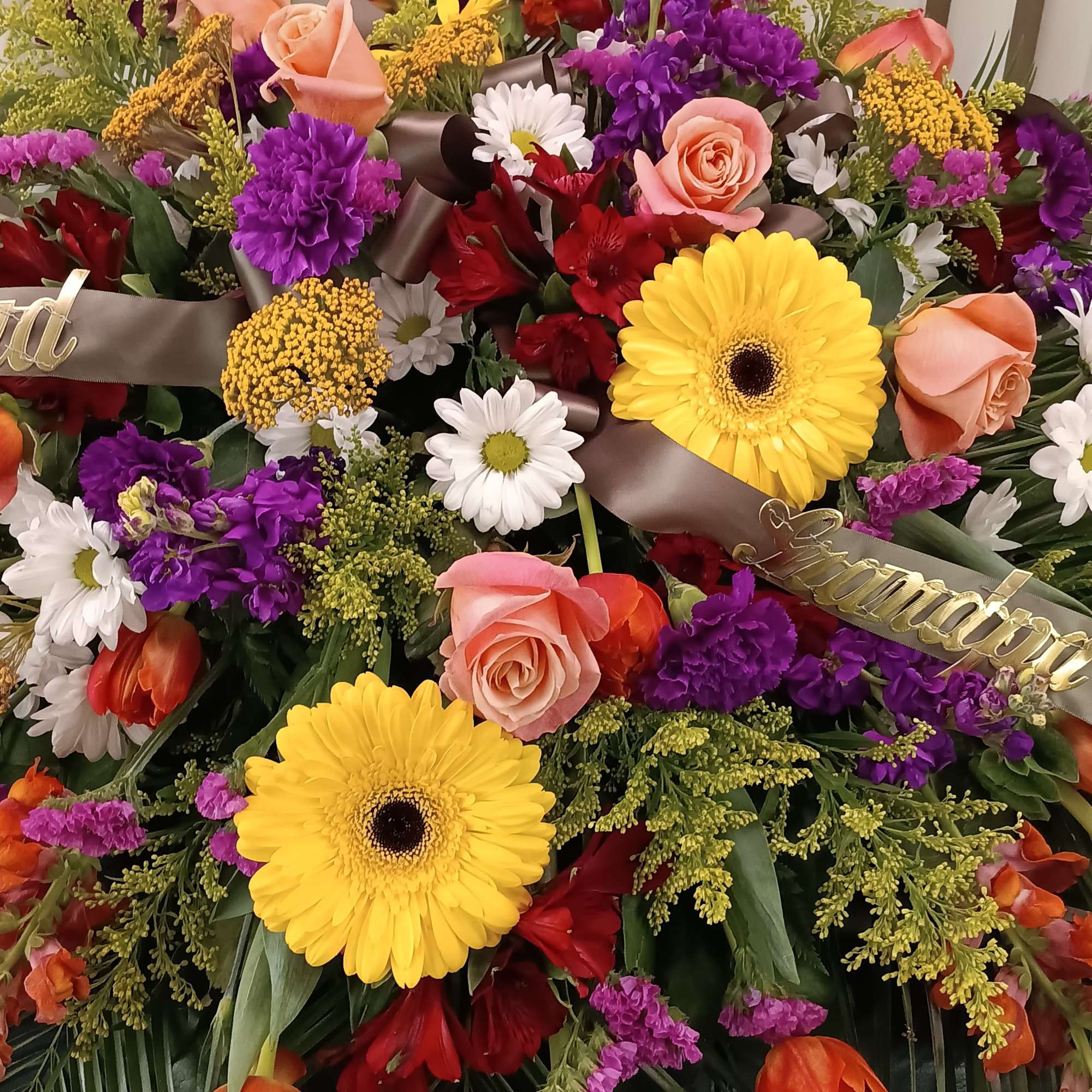 Colorful mixed flower arrangement with roses, gerbera daisies, and tulips