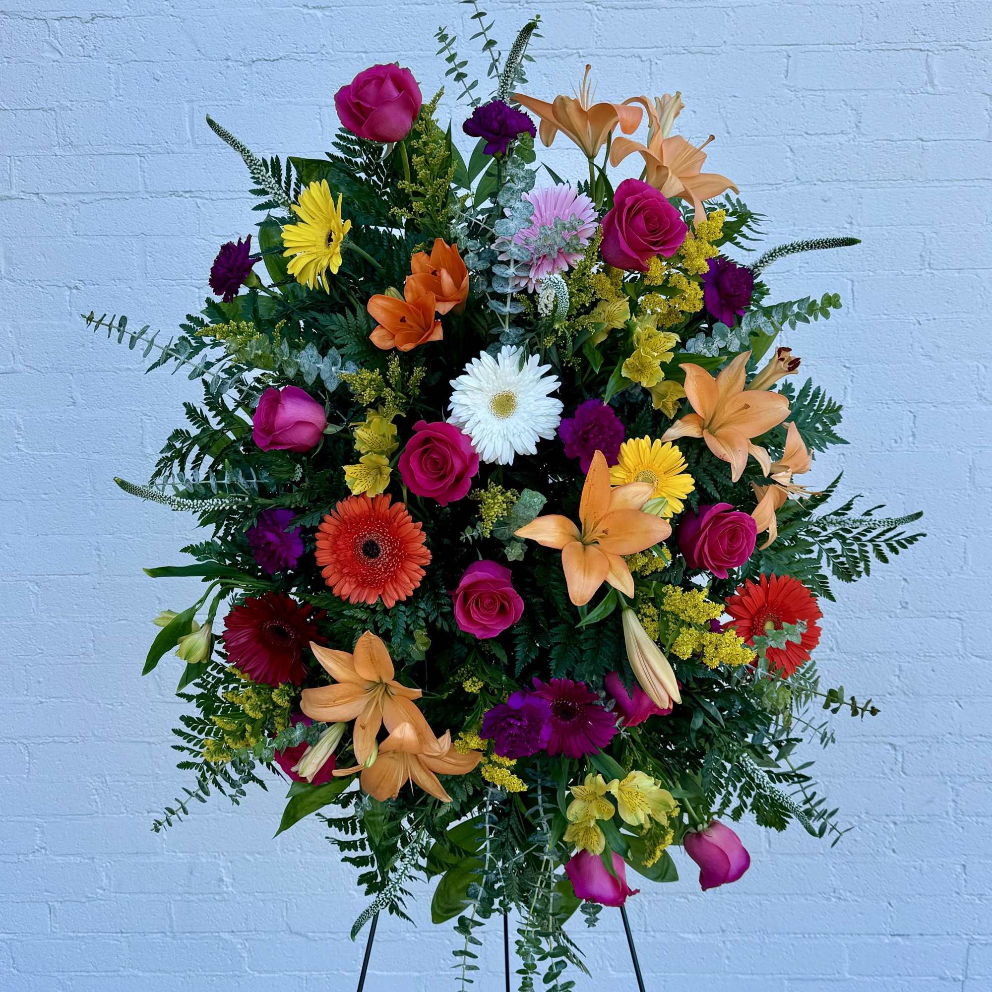 A dense, upright standing spray that commands attention with a vivid mix