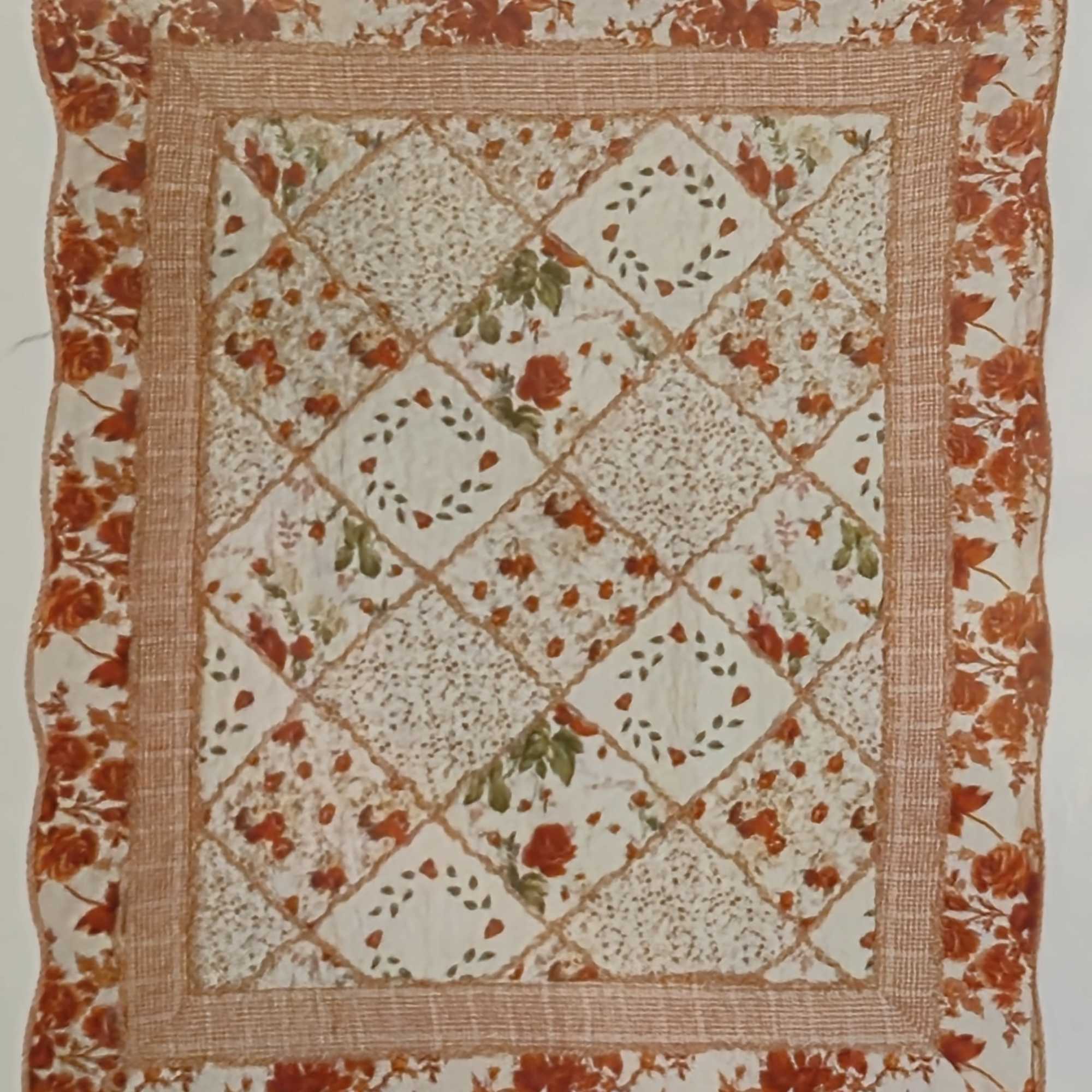 A cozy, country-inspired square quilted throw in warm burnt orange and cream