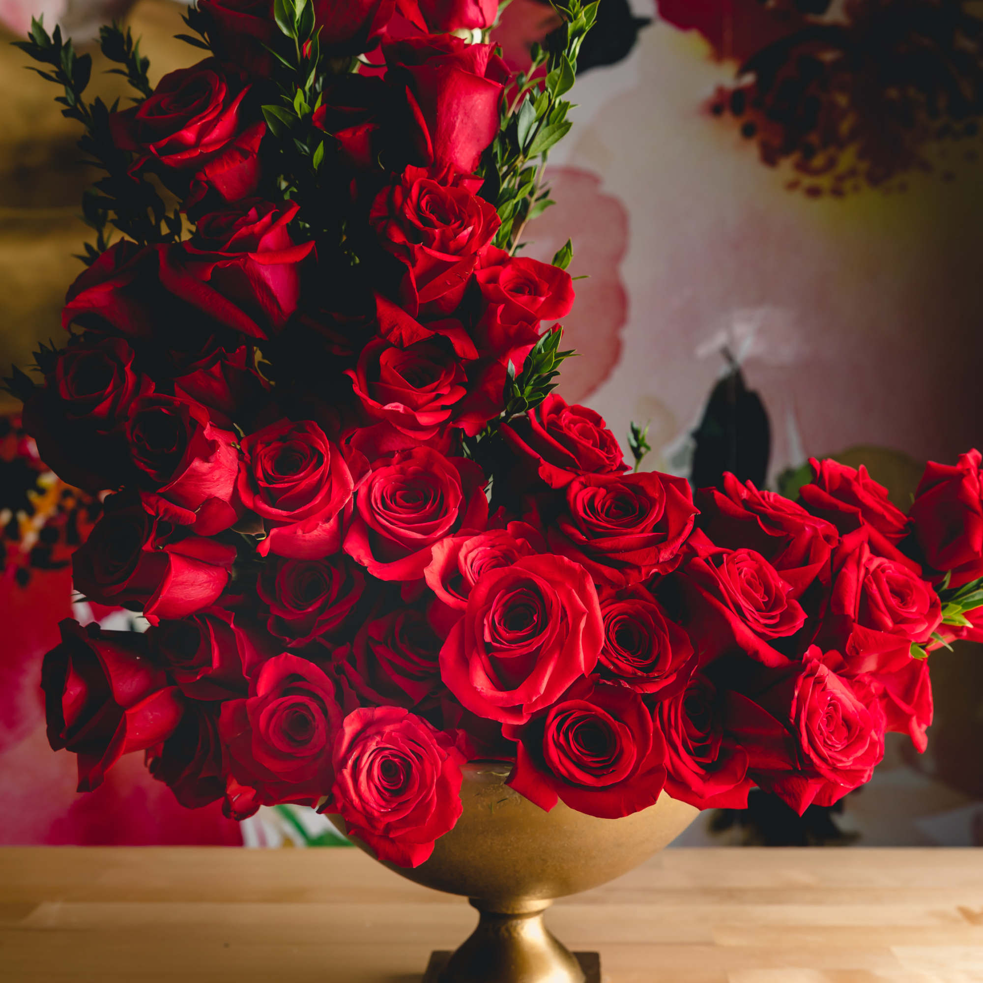 A dramatic sculptural spray of vivid red roses makes a commanding statement