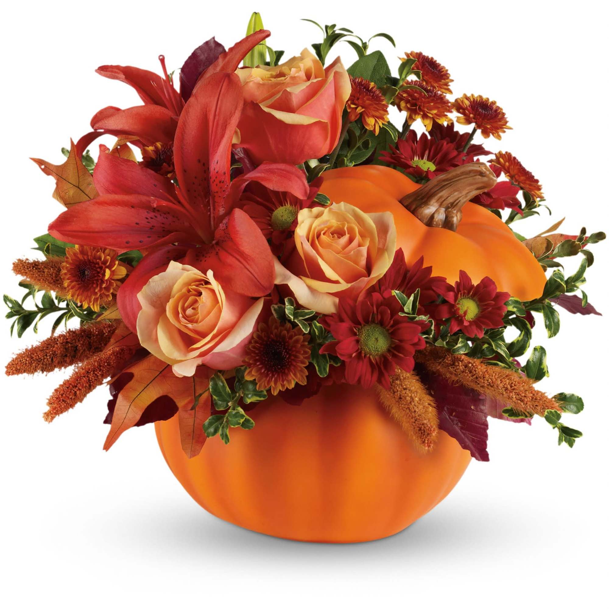 Autumn floral arrangement in a pumpkin container with red lilies and roses
