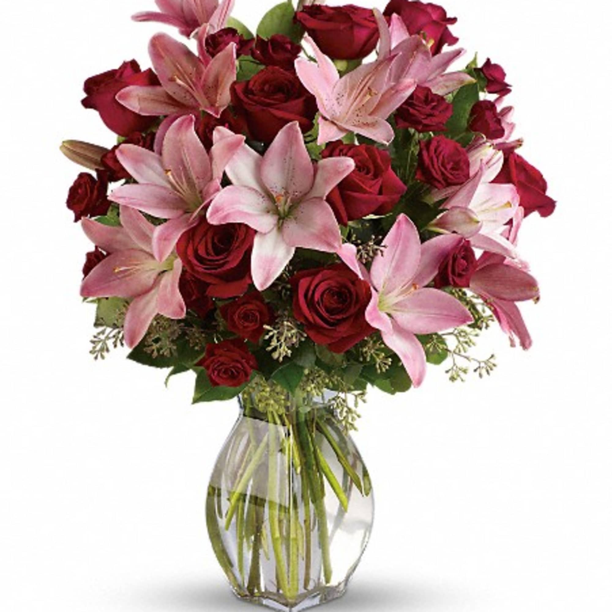 Bouquet of red roses and pink lilies in a clear glass vase, photo 3 of 3