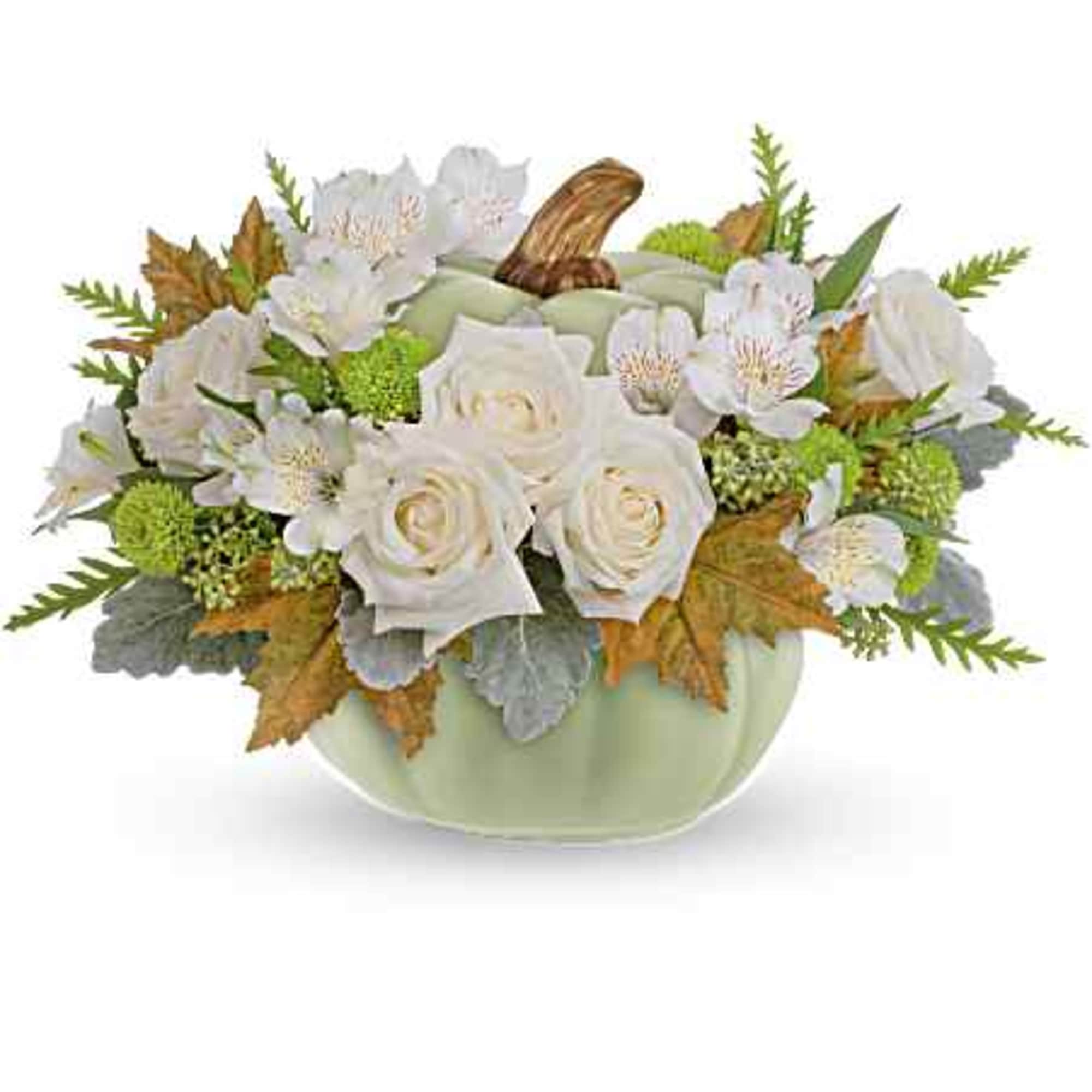 White roses and small white flowers in a pale green vase
