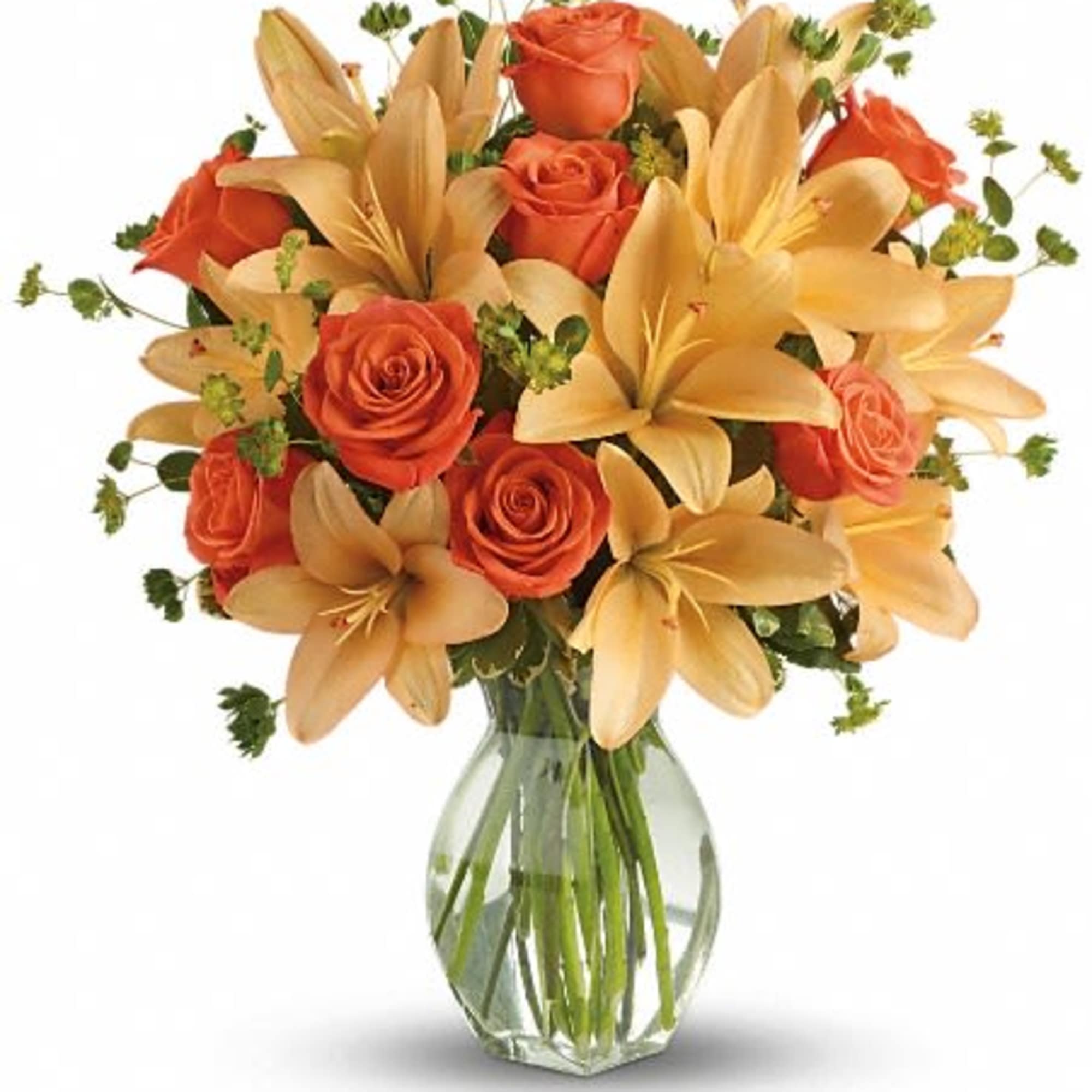 Orange roses and peach lilies in a clear glass vase