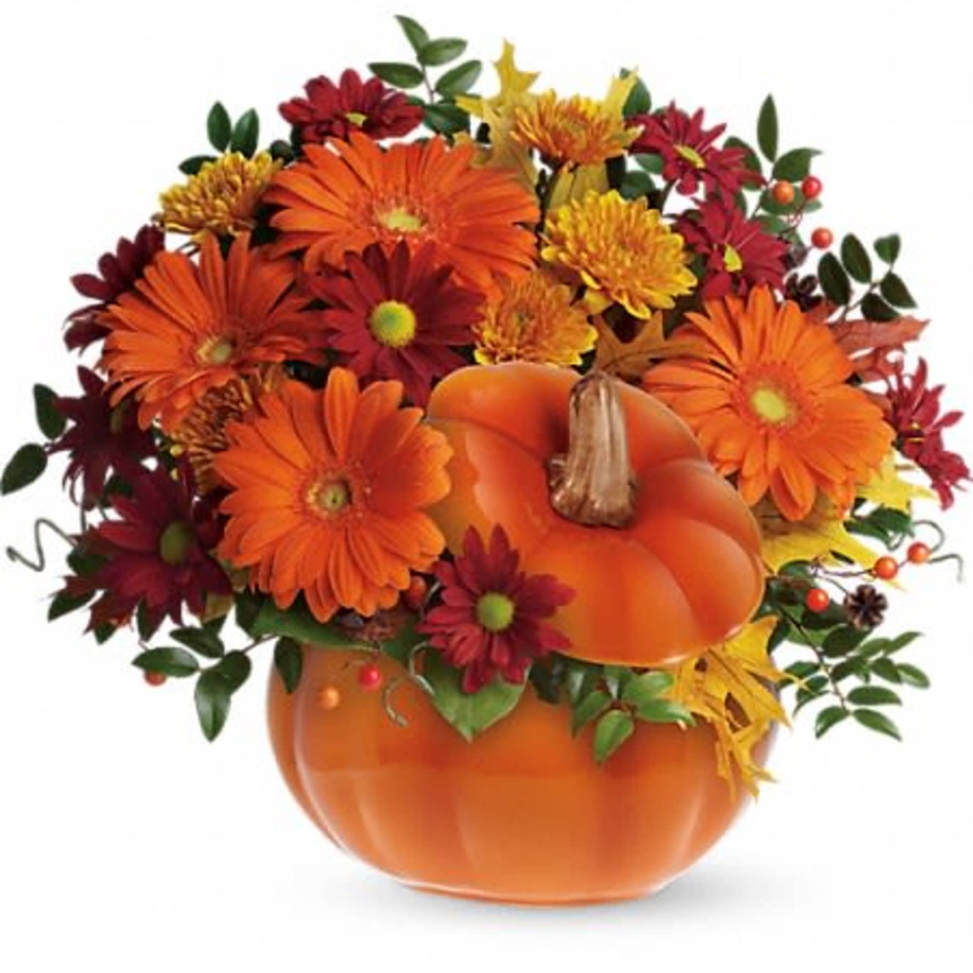 Orange pumpkin container filled with orange and red flowers