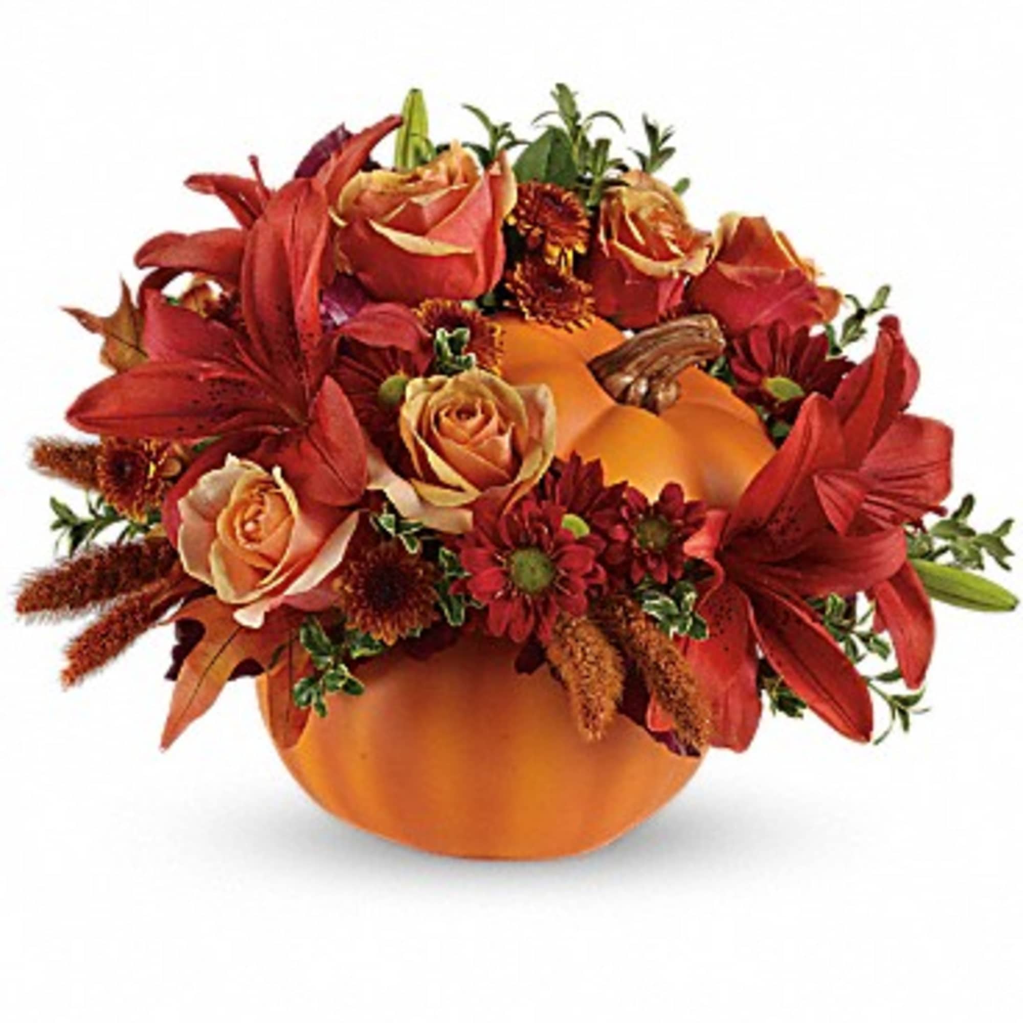 Orange pumpkin centerpiece with red lilies and roses