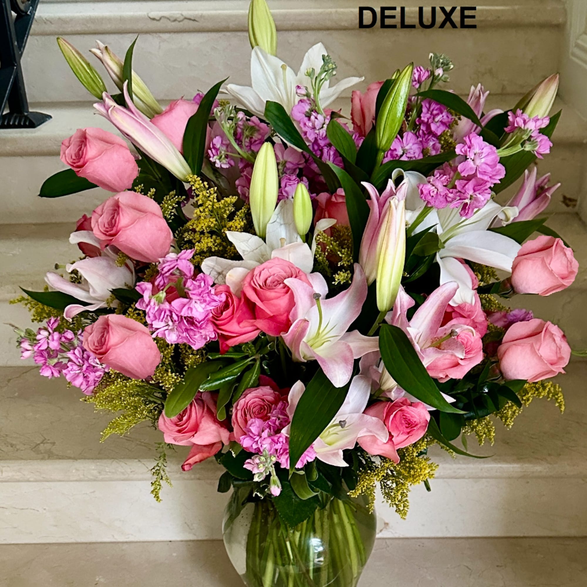 Pink roses and white lilies in a glass vase