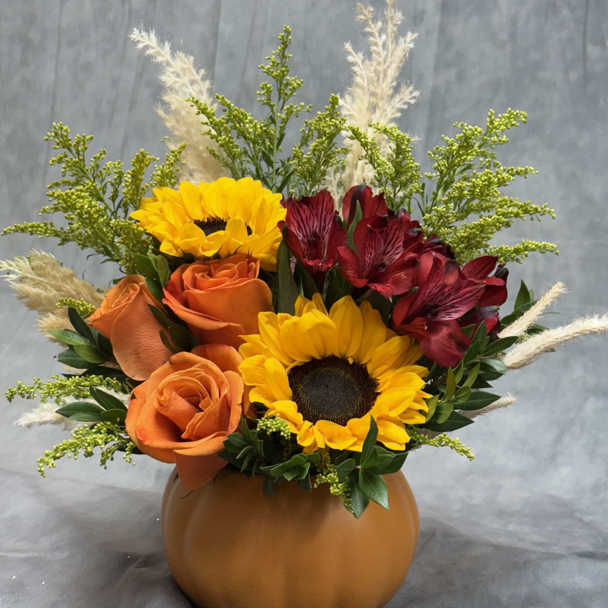 A warm, cheerful fall arrangement bursting with seasonal charm. 
This design features, photo 2 of 2