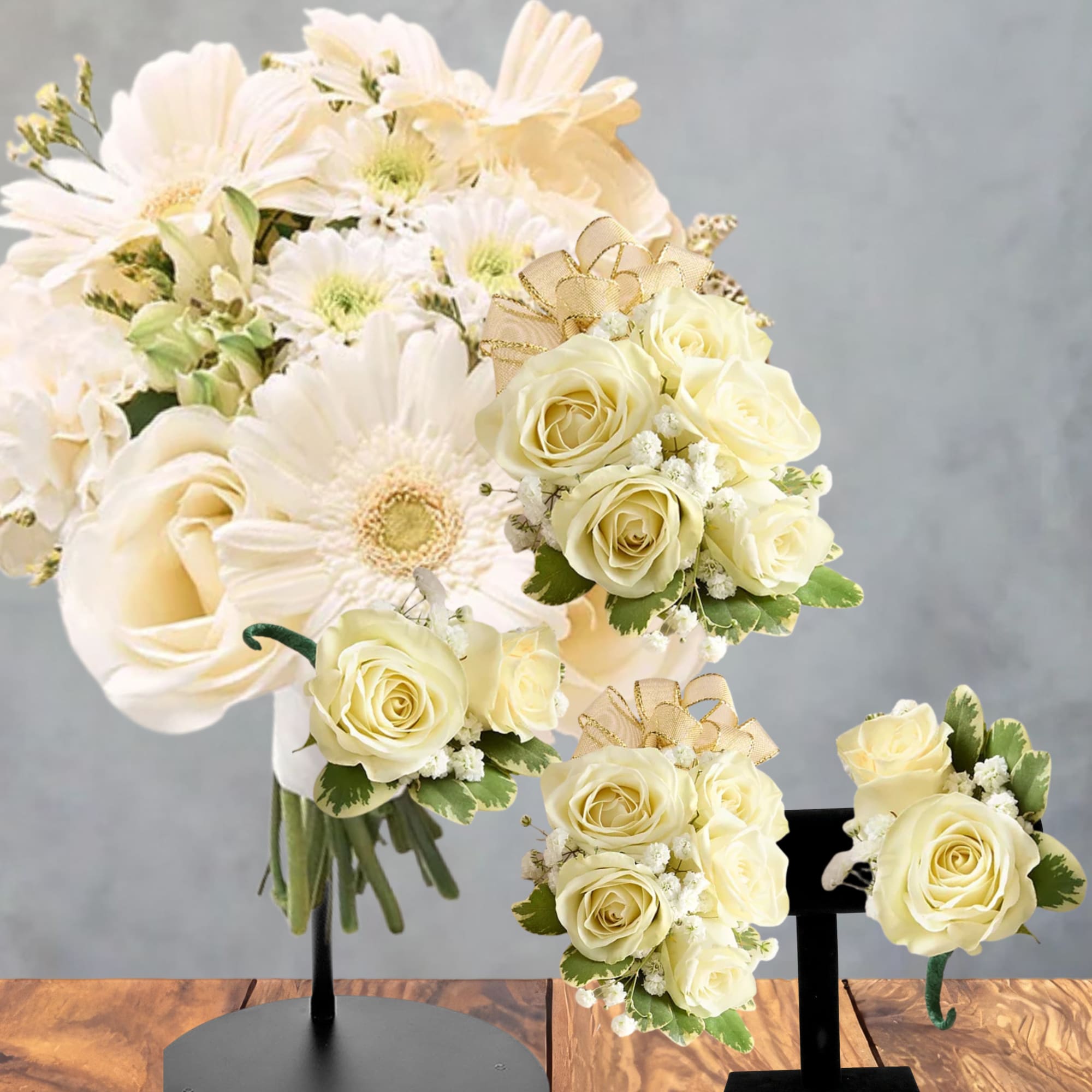 Cream rose and daisy bouquet with matching boutonnieres on display stands