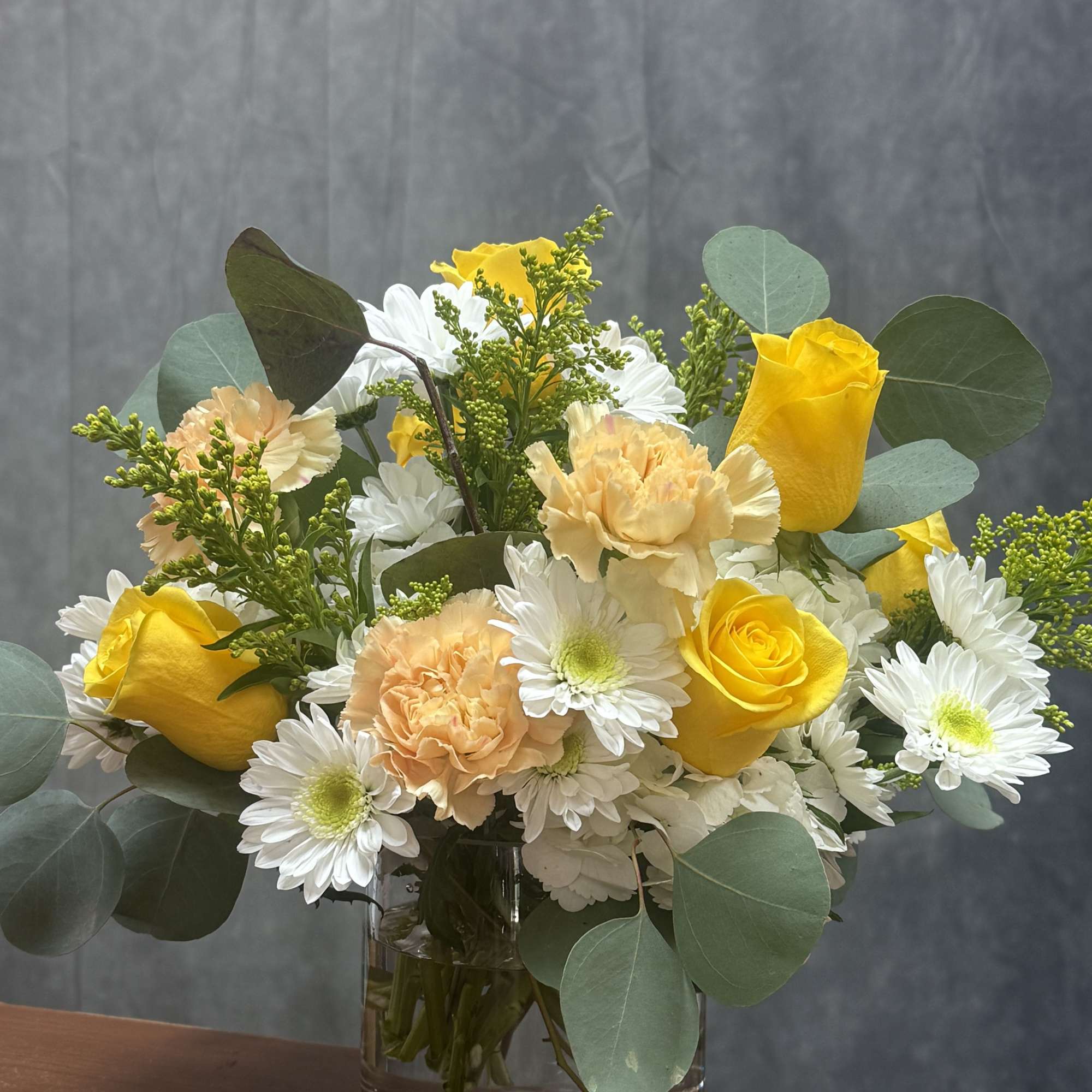 A vibrant arrangement of roses and carnations and delicate filler ,creating a, photo 2 of 2