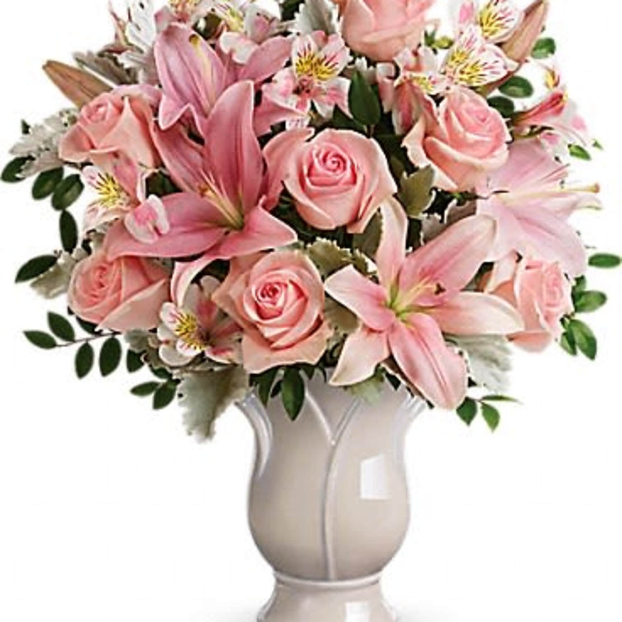 Pink roses and lilies arranged in a white vase
