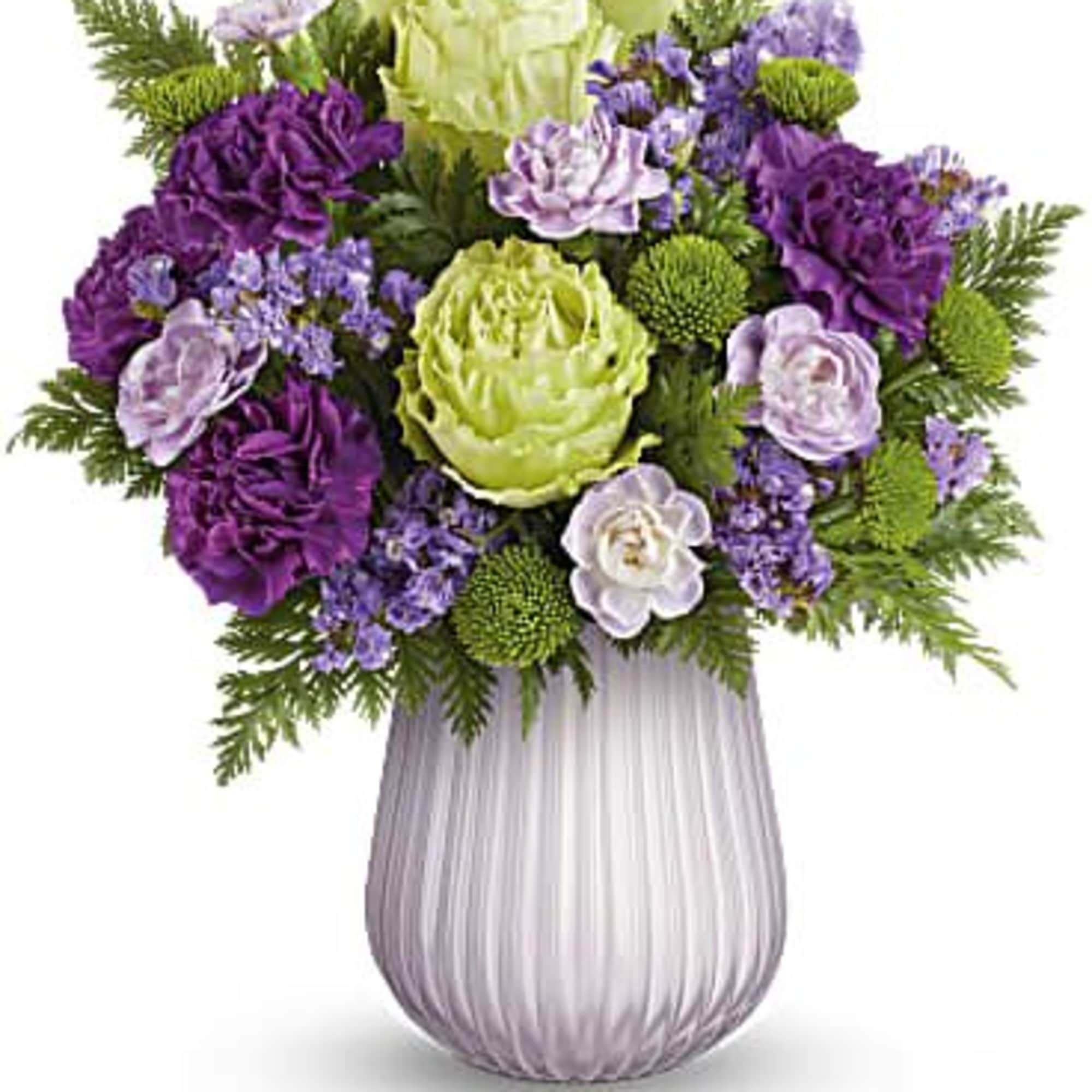 Purple and green floral arrangement in a ribbed glass vase
