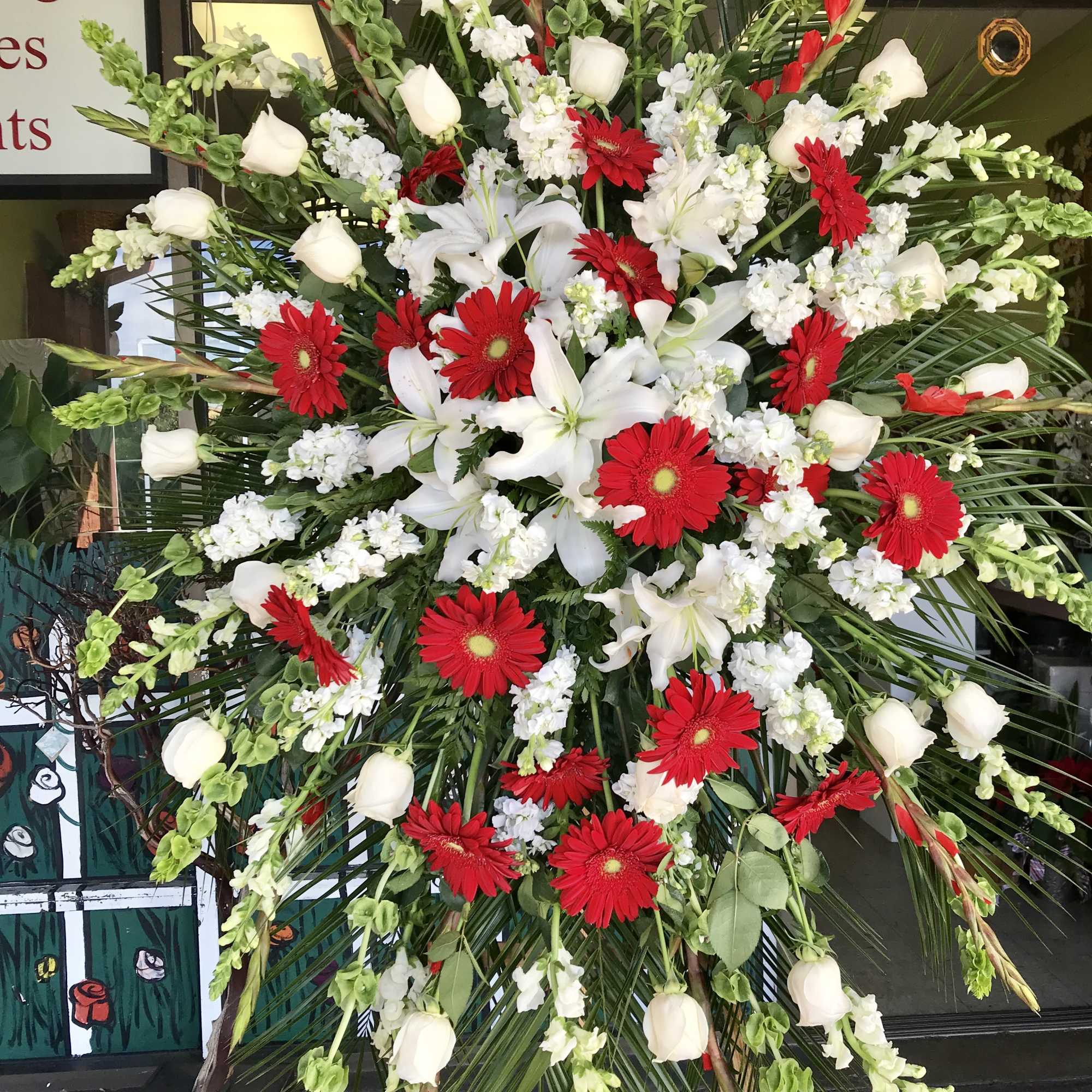 Large standing spray with red gerberas, white roses, and white lilies