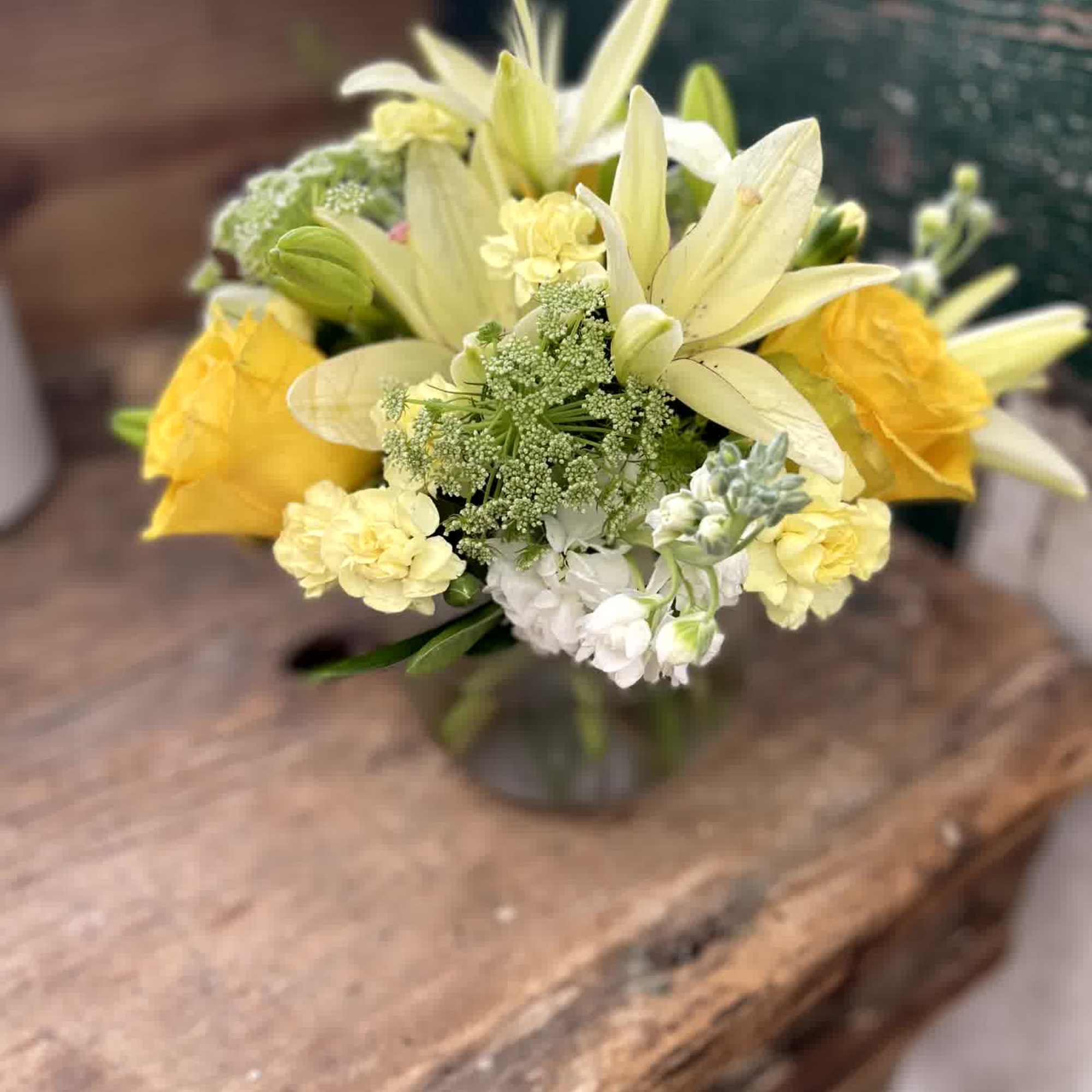 Yellow and white flower bouquet in a glass vase