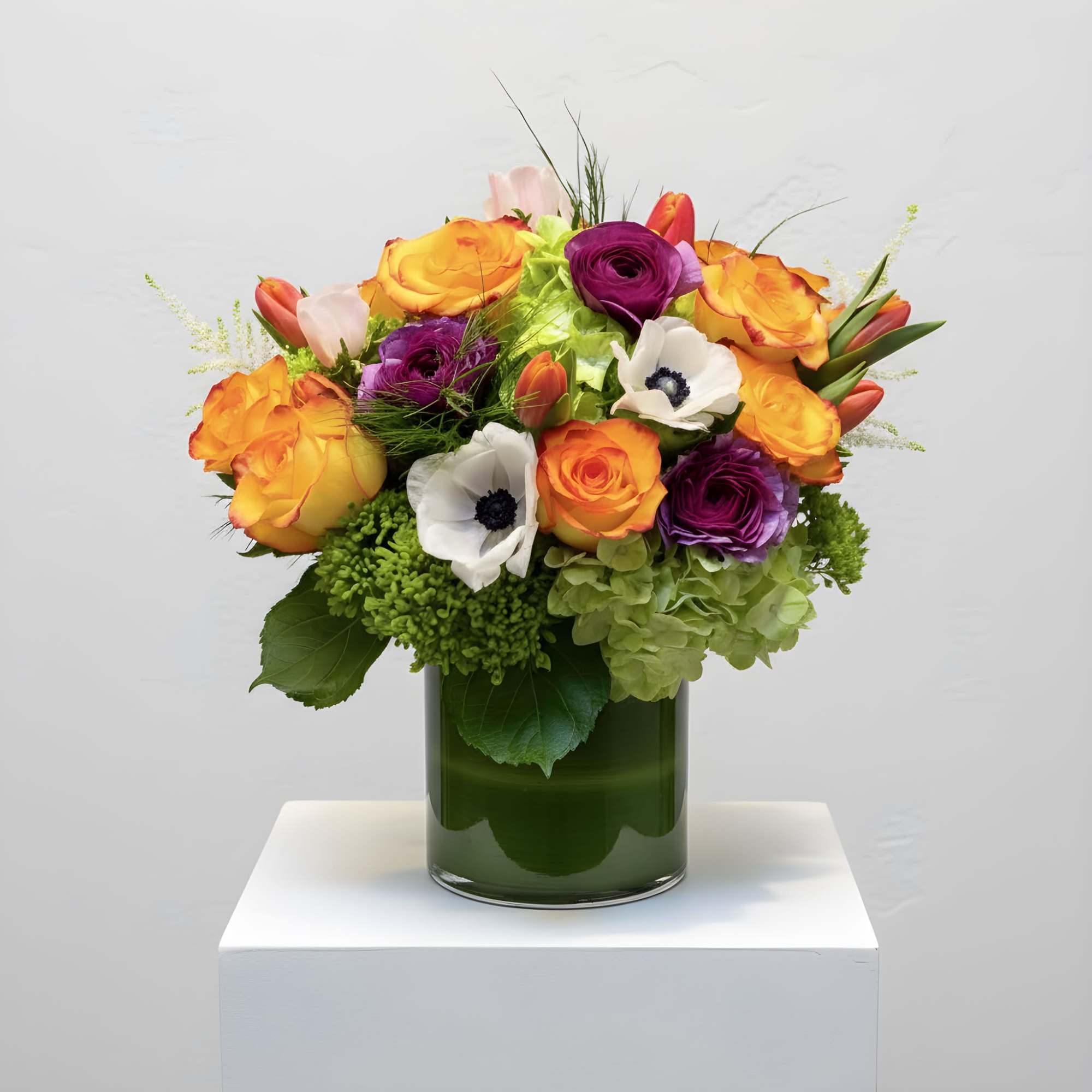 Designed in a tall glass cylinder, vibrant hues shine bright in this