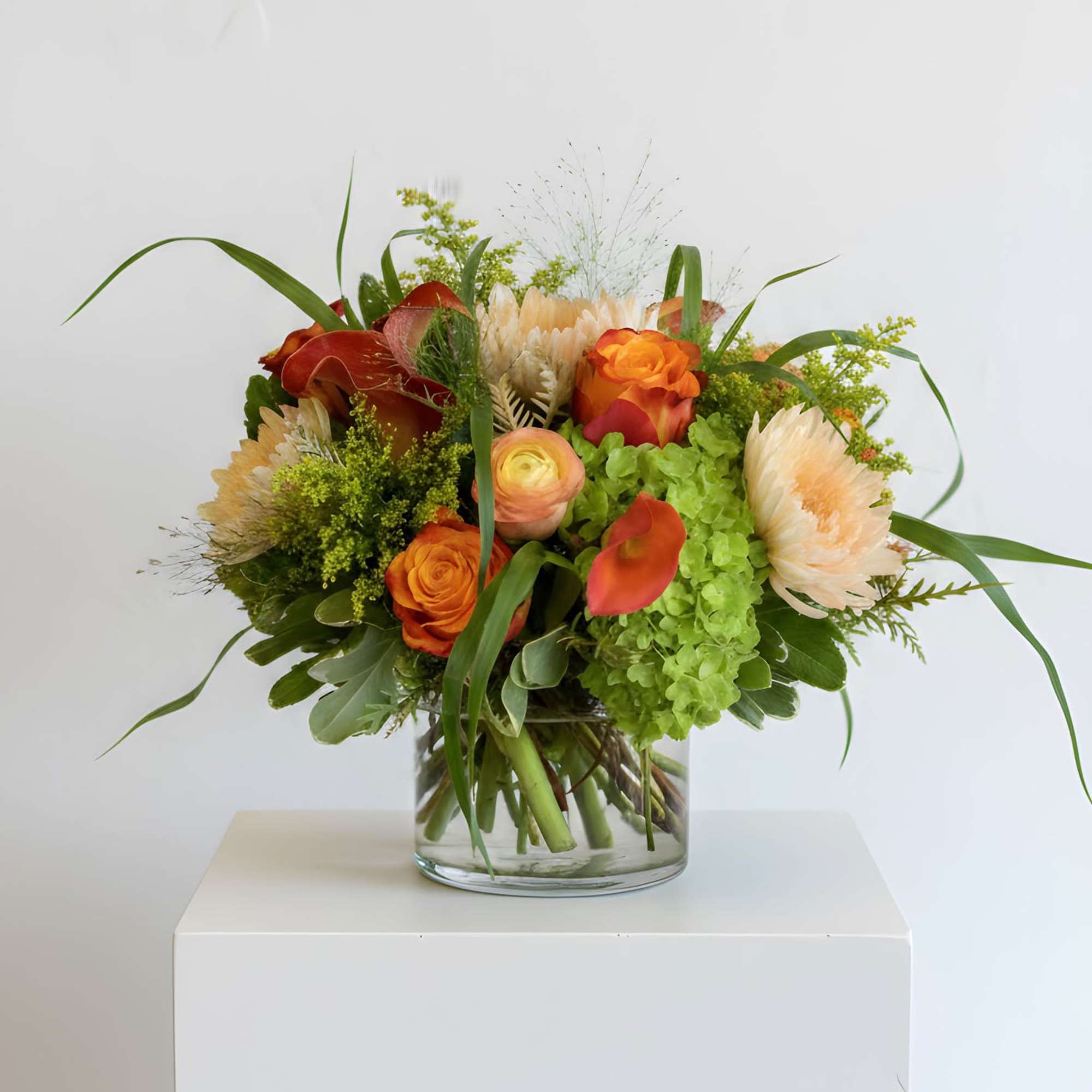 This vibrantly colored yellow and orange arrangement is sure to delight any