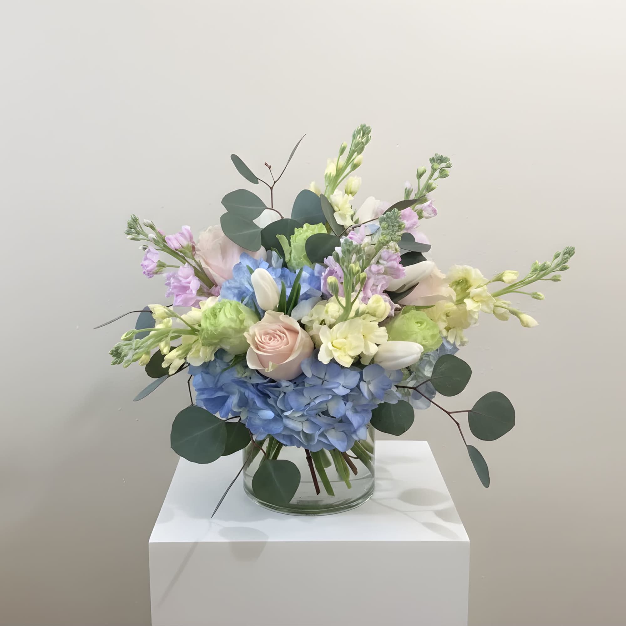 Designed in a glass cylinder, this arrangement highlights the calming properties of