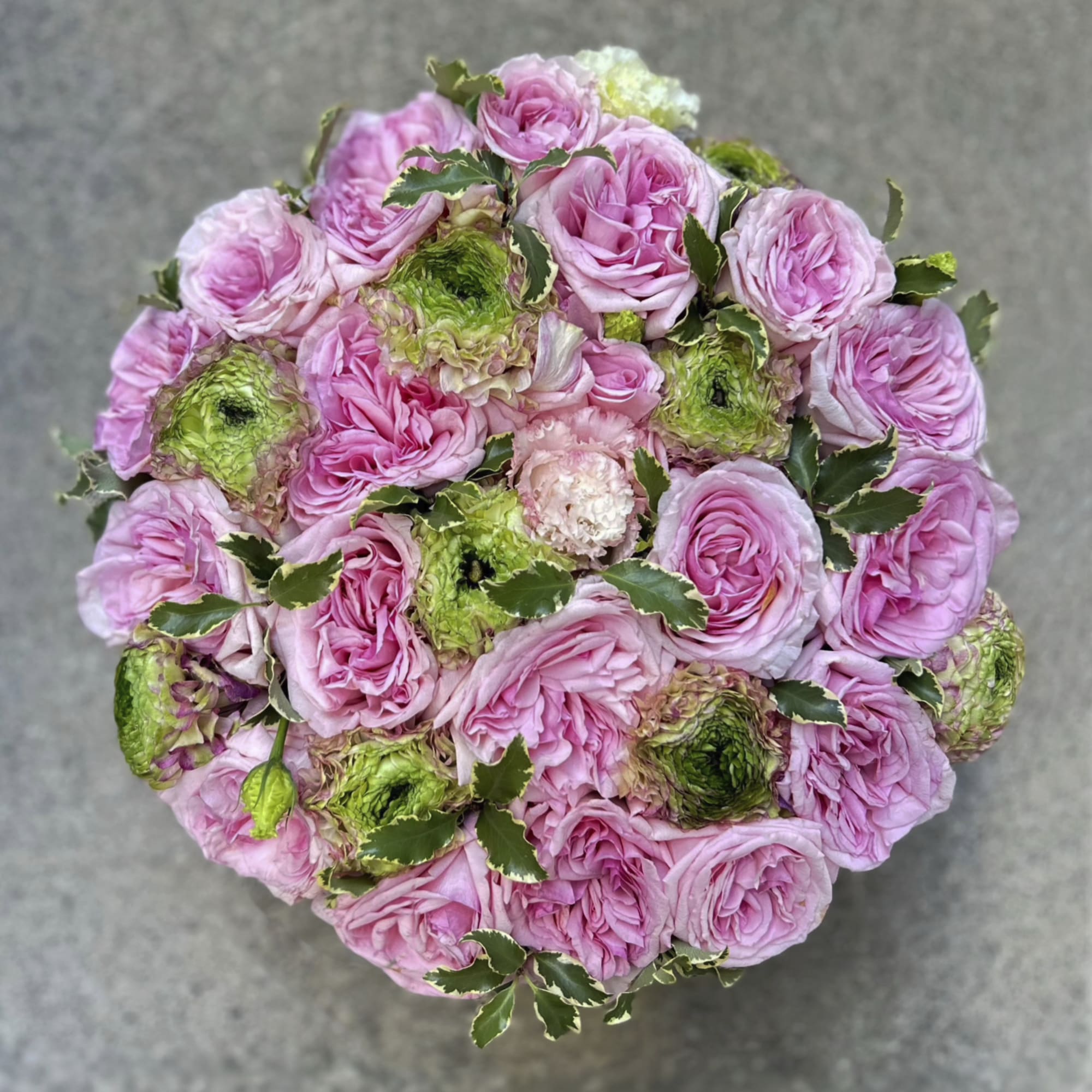 Round bouquet of pink roses with green-centered blooms