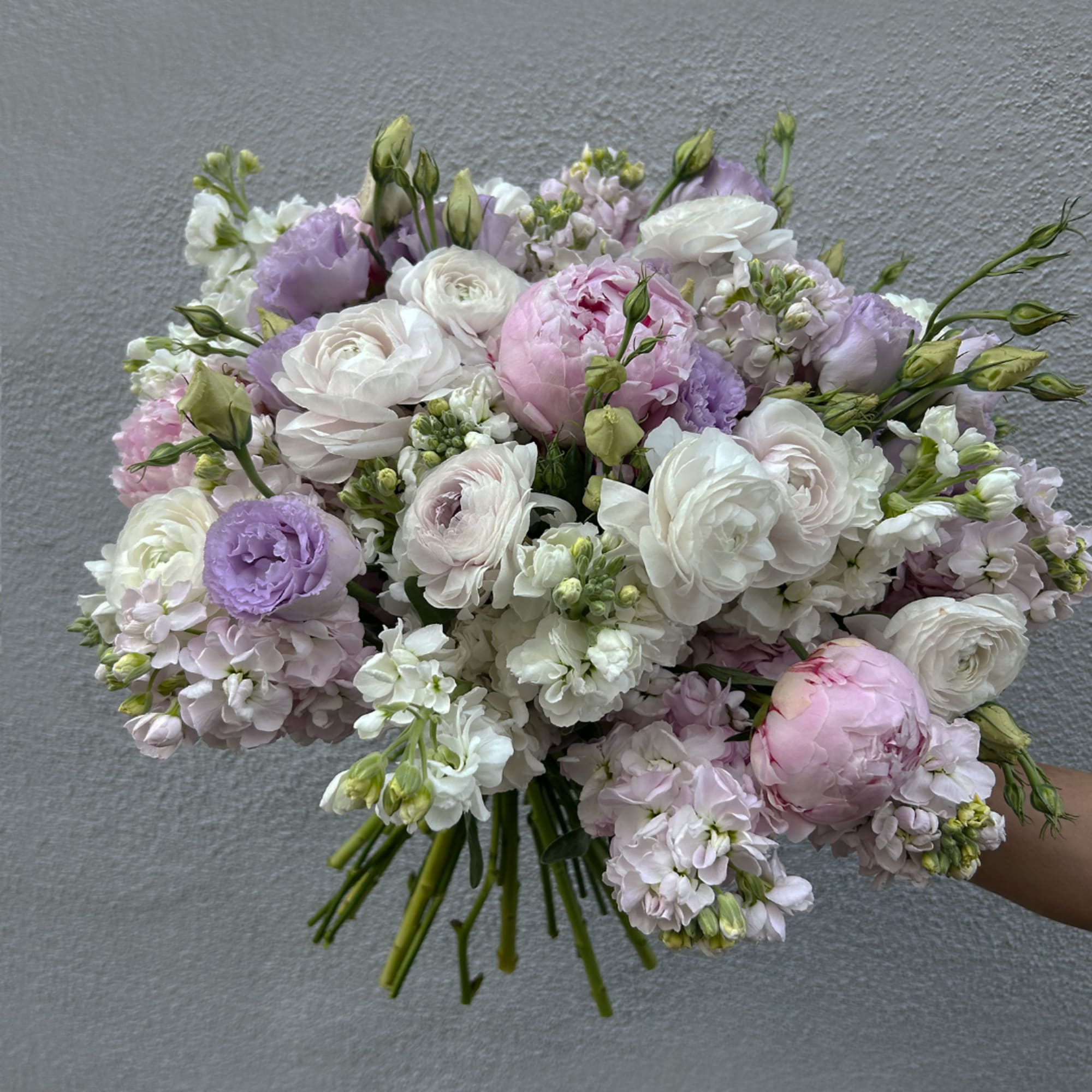 Hand-tied bouquet of white, pink, and lavender flowers