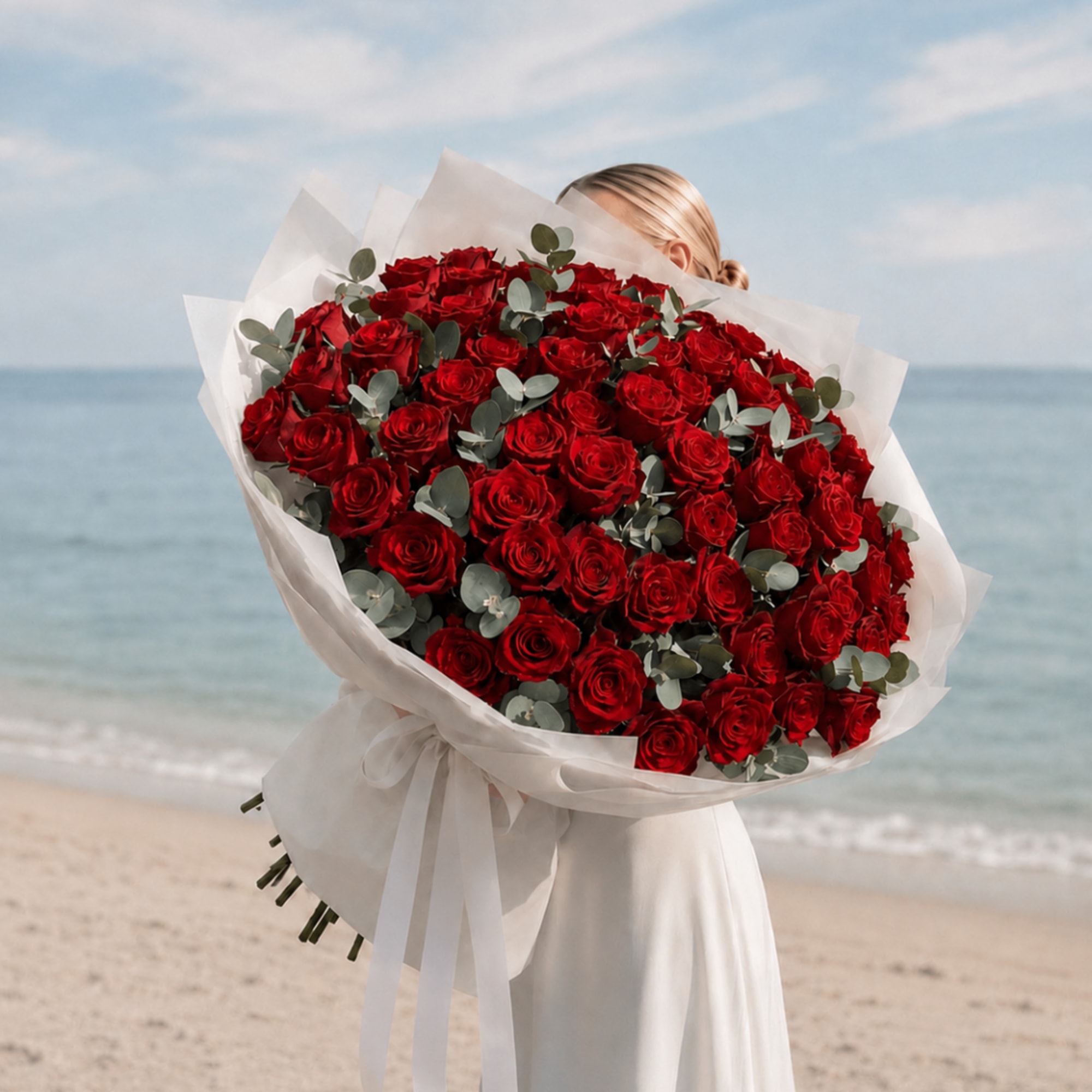 Large bouquet of red roses wrapped in white paper