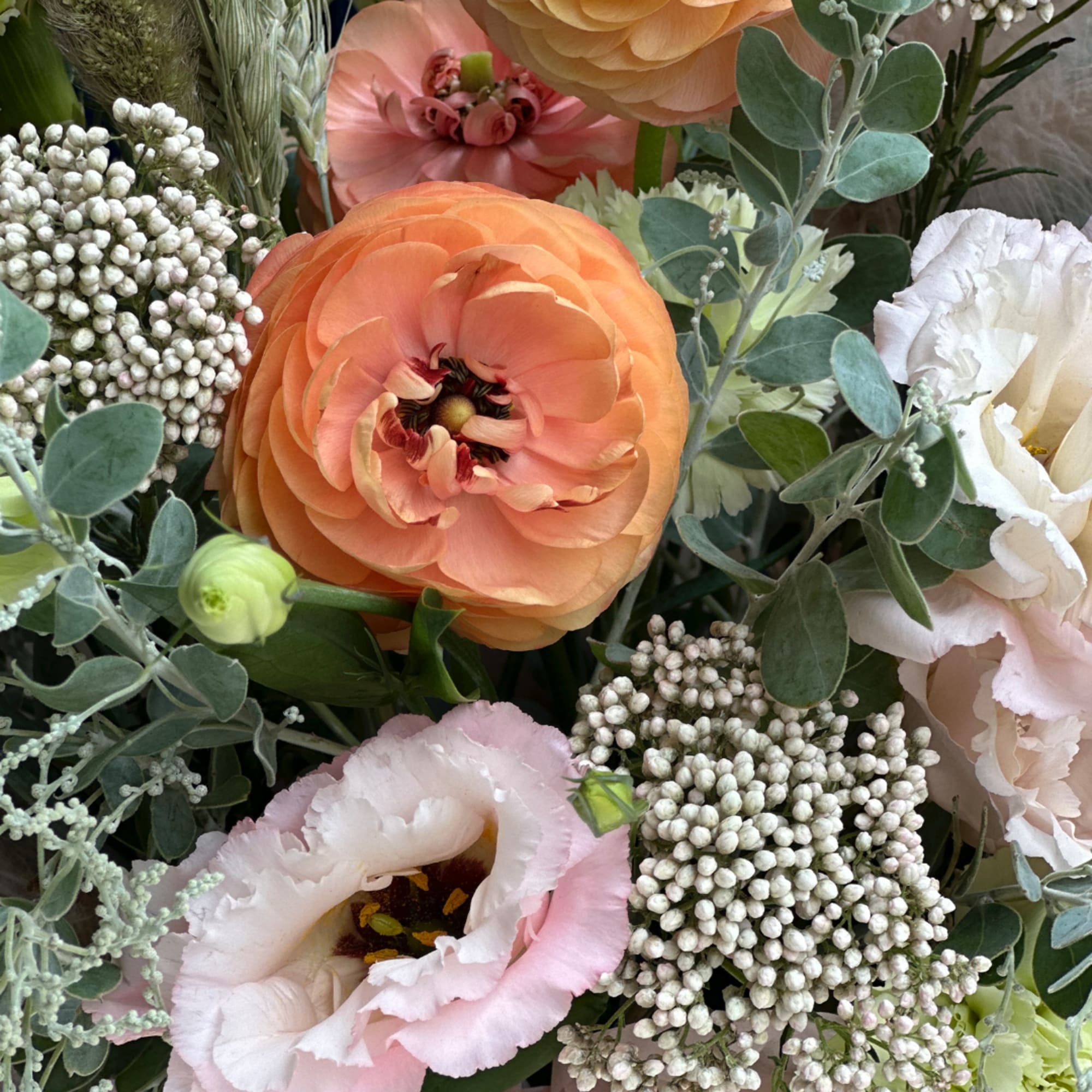 Close-up bouquet with peach, pink, and white blooms